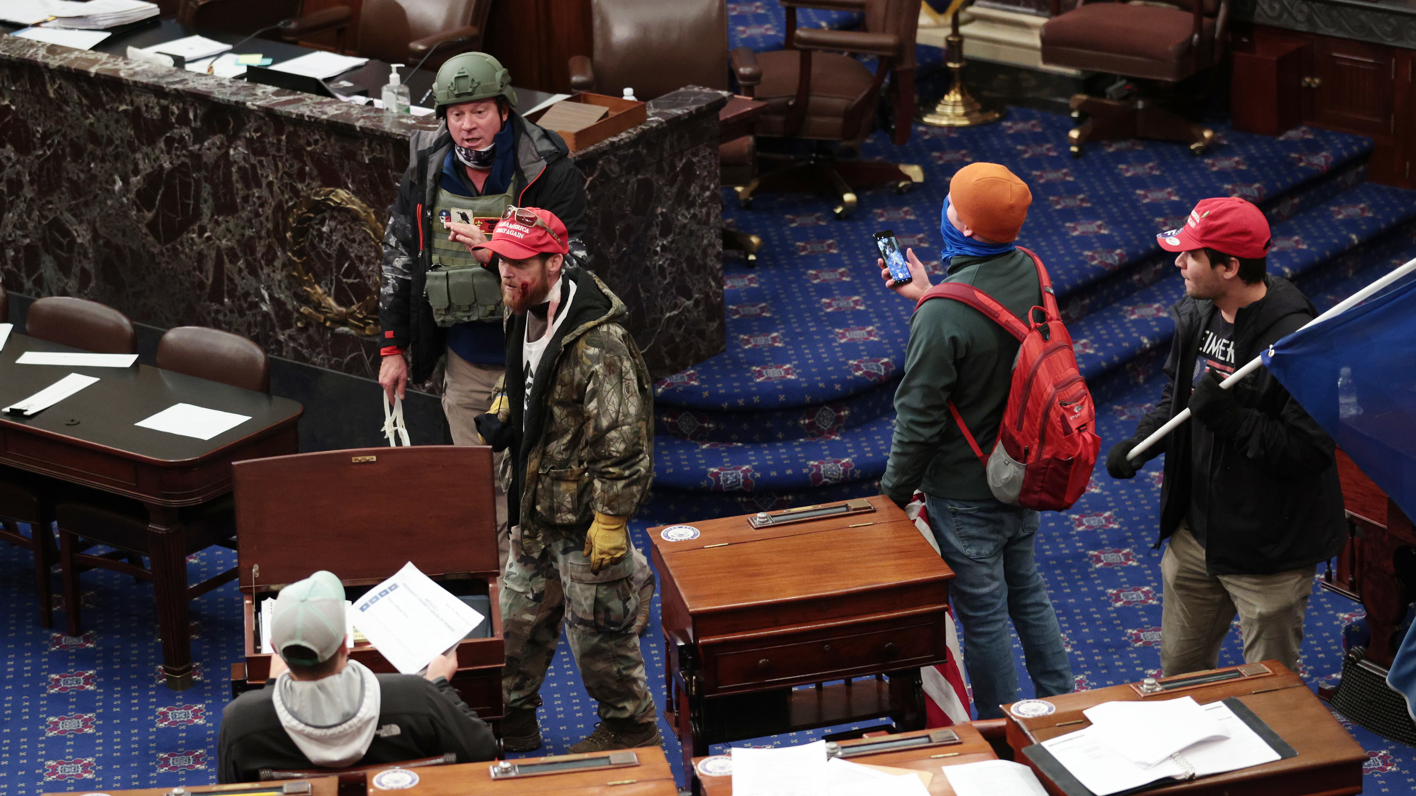 Larry Rendall Brock Jr., an Air Force veteran, is seen inside the Senate Chamber wearing a military-style helmet and tactical vest during the rioting at the U.S. Capitol. Federal prosecutors have alleged that before the attack, Brock posted on Facebook about an impending &quot;Second Civil War.&quot; (Getty Images)