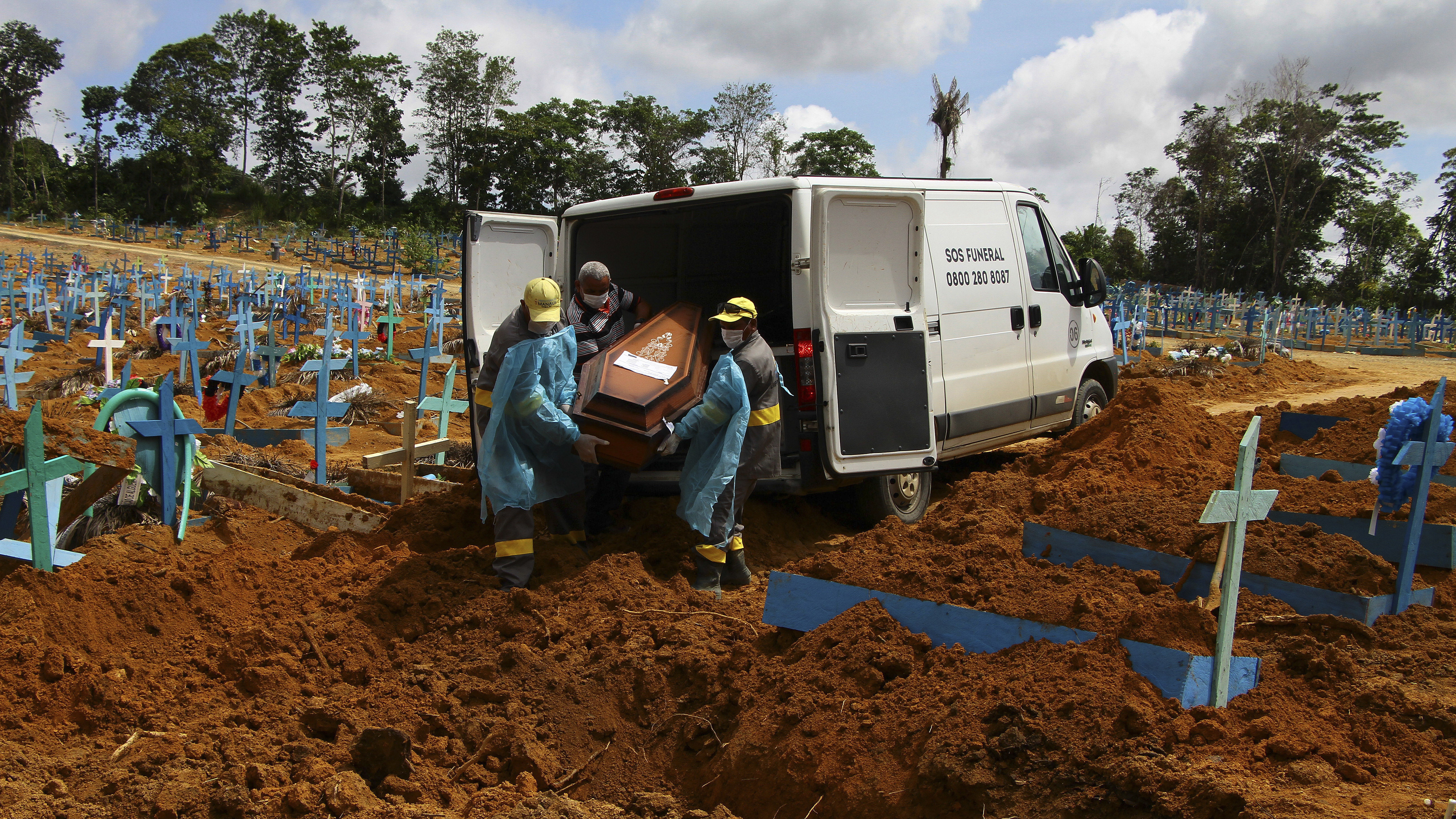 Cemetery workers carry the remains of 89-year-old Abilio Ribeiro, who died of the new coronavirus, for burial at the Nossa Senhora Aparecida cemetery in Manaus, Amazonas state, Brazil, on Jan. 6. The day before, Manaus declared a 180-day state of emergency due to a surge of new cases of the coronavirus.