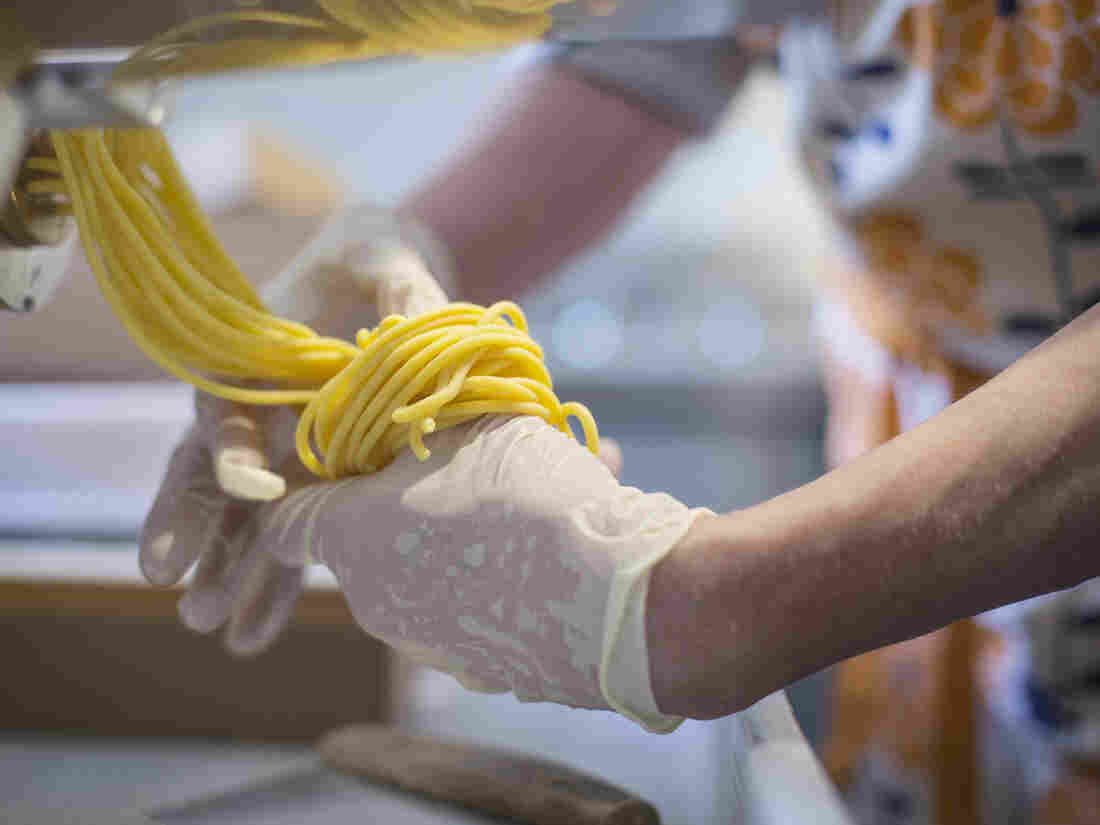 GOULDSBORO, ME - JULY 11: Kelli Grover wraps Bucatini pasta into nests as it comes out of a Itagli pasta machine at Raven's Nest Farm in Goulsdboro. (Staff photo by Derek Davis/Portland Portland Press Herald via Getty Images)