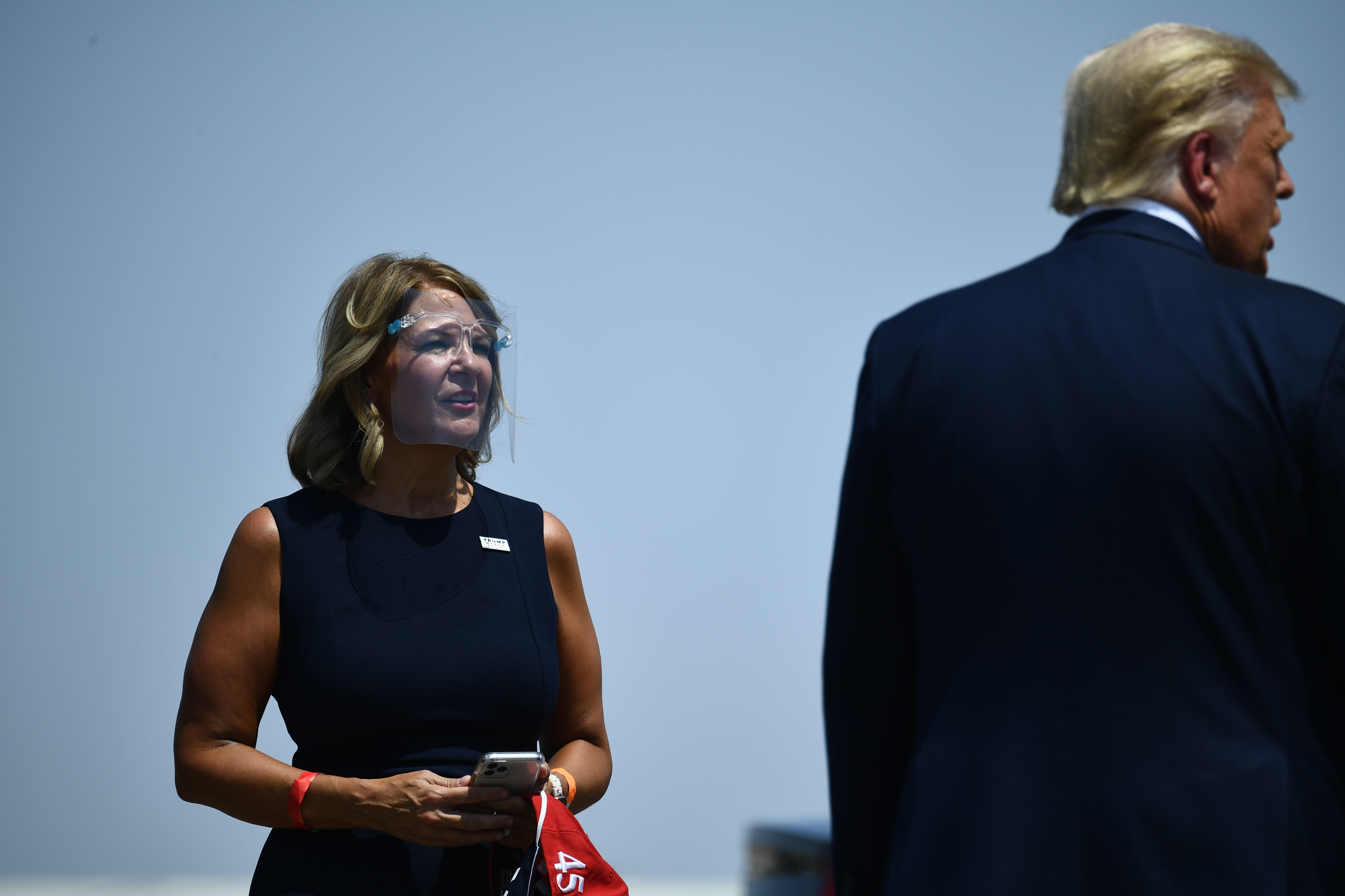 Then-President Donald Trump is greeted by Kelli Ward, chair of the Arizona Republican Party, during a stop in Arizona last year. (AFP via Getty Images)