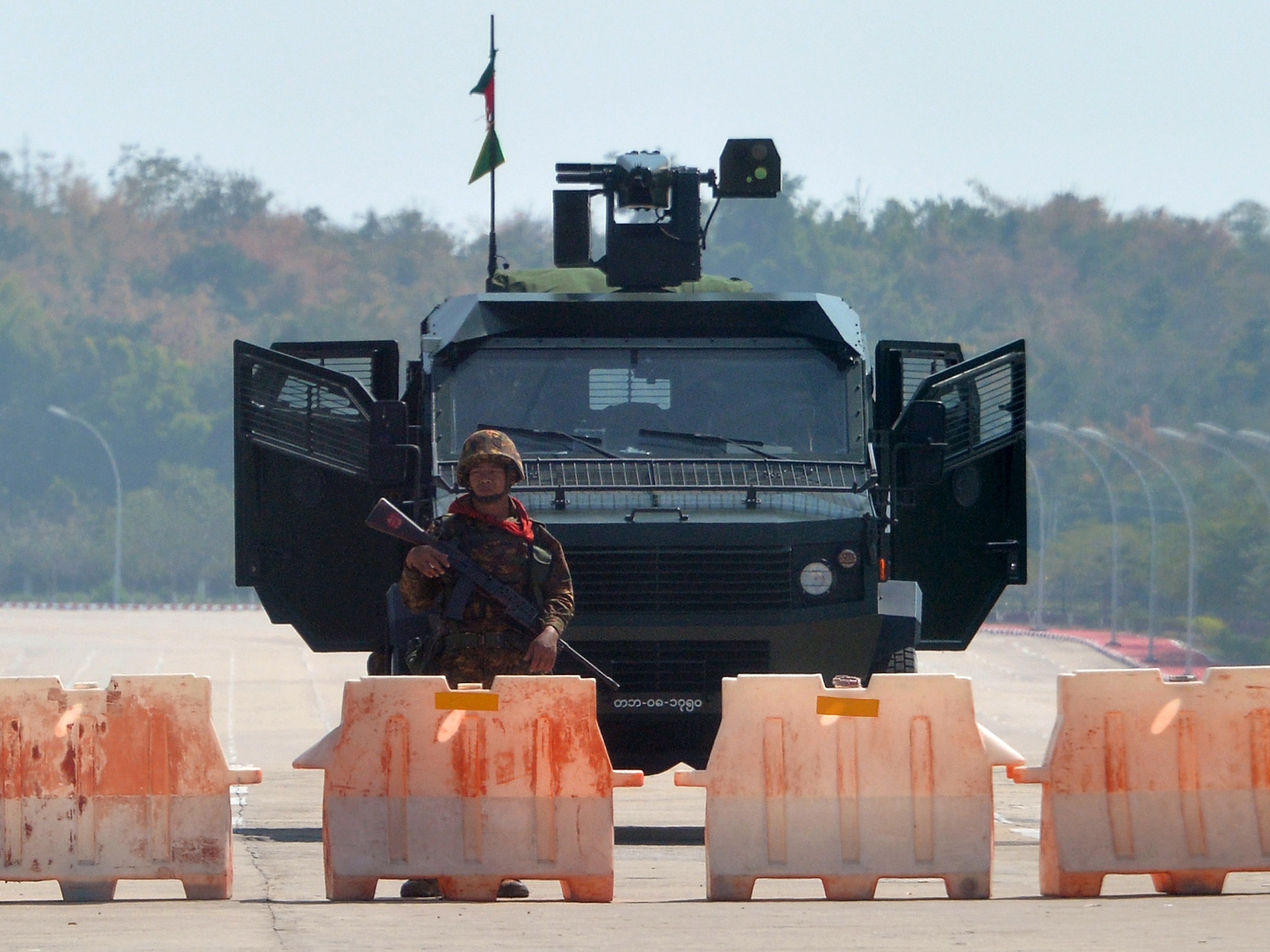 A soldier stands guard on a blockaded road to Myanmar's parliament in Naypyidaw on Monday, after the military detained the country's de facto leader Aung San Suu Kyi and other officials and activists. (AFP via Getty Images)