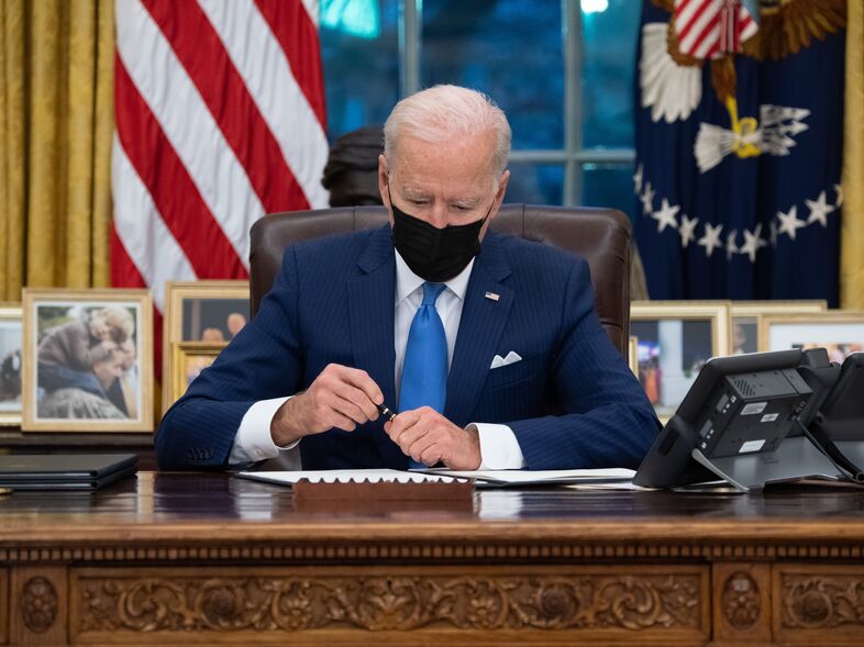President Biden signed three executive orders related to immigration on Tuesday. His aides said work to reverse his predecessor's immigration policies has only just begun. (Saul Loeb/AFP via Getty Images)