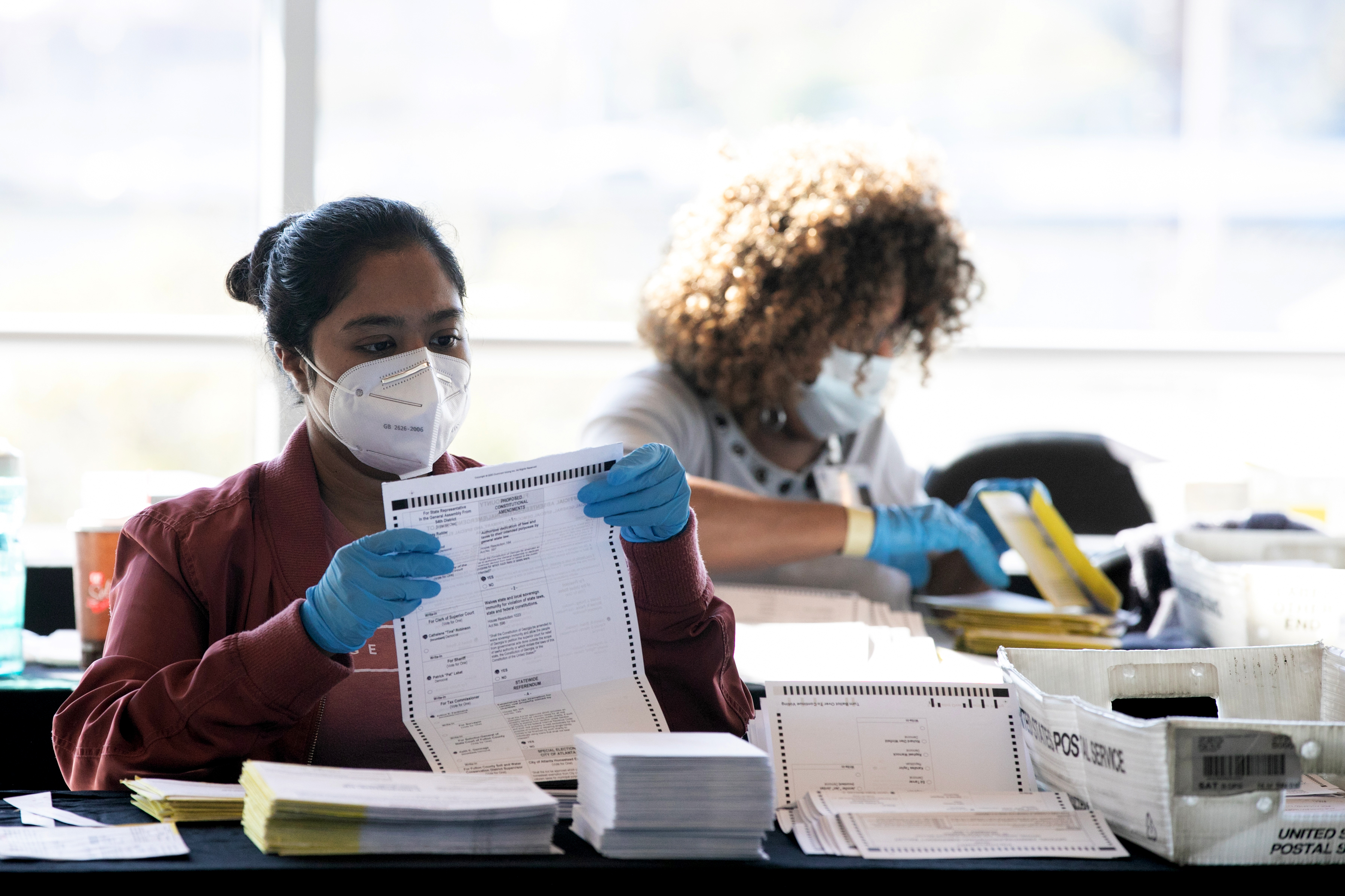 Election workers count Fulton County ballots at State Farm Arena on Nov. 4, 2020 in Atlanta. Falsehoods spread by former President Trump and his allies led to threats against election workers. (Getty Images)