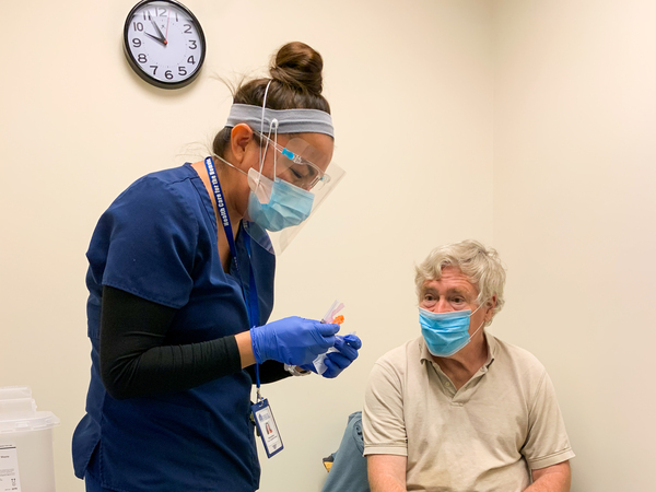 Nurse Modesta Littleman vaccinates patient Peter Sulewski in late January, on the first day of vaccinations at a clinic run by Health Care for the Homeless in Baltimore.