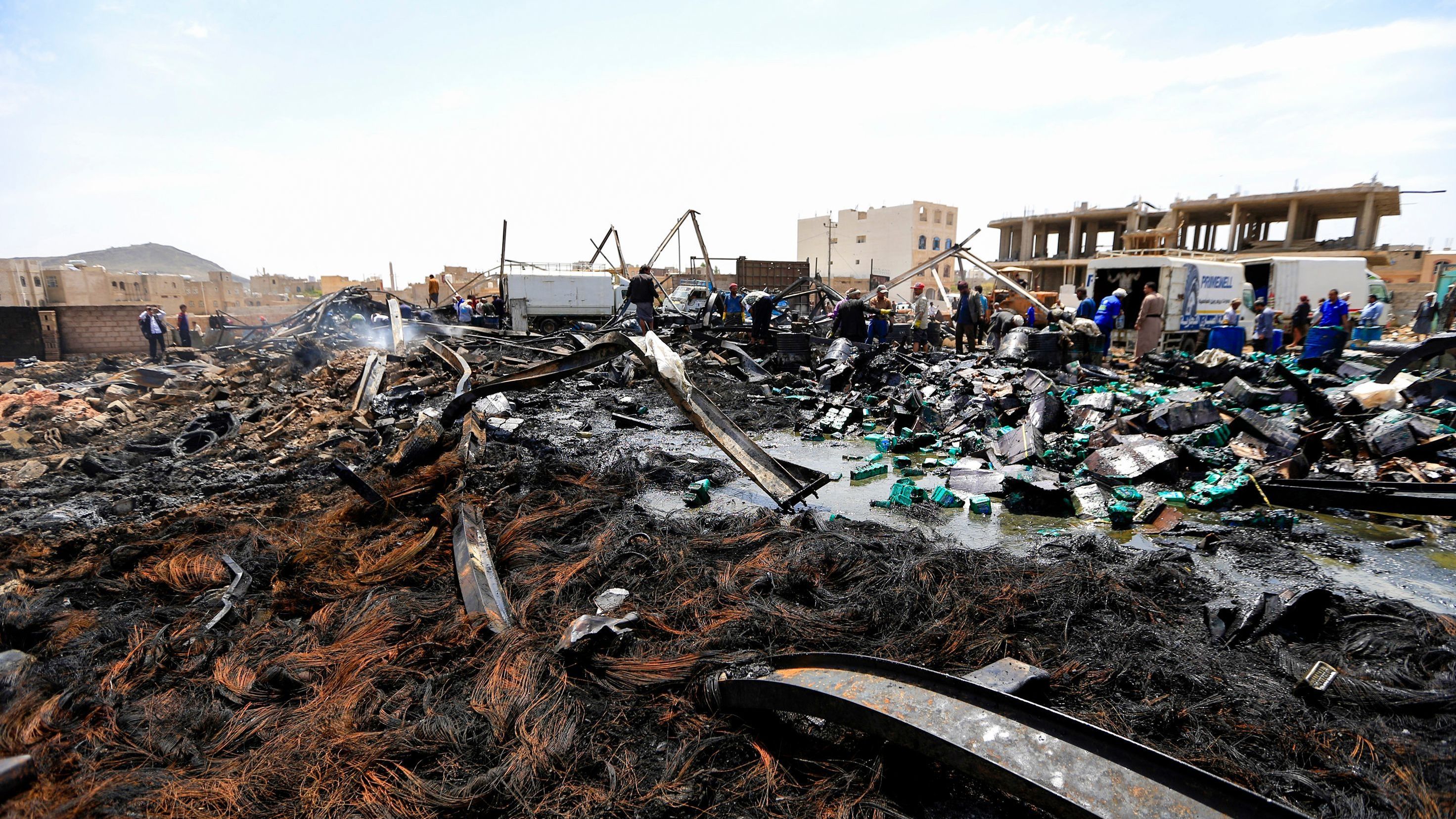 Workers search through debris at a warehouse, after it was reportedly hit in an airstrike by the Saudi-led coalition, in the Yemeni capital Sanaa on July 2, 2020. More than 233,000 people have died as a result of the war. (AFP via Getty Images)