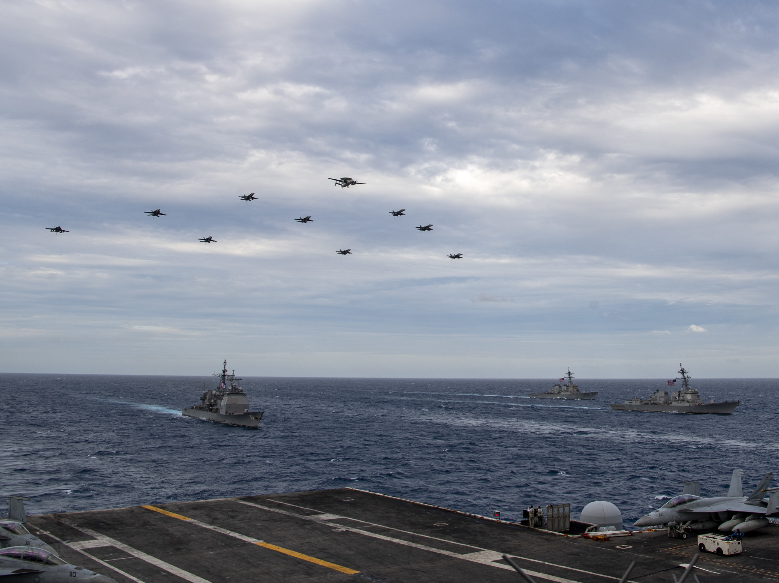Aircraft assigned to Carrier Air Wing (CVW) 17 fly over the Theodore Roosevelt Carrier Strike Group and the Nimitz Carrier Strike Group in the South China Sea on Tuesday. (USS Theodore Roosevelt (CVN 71))