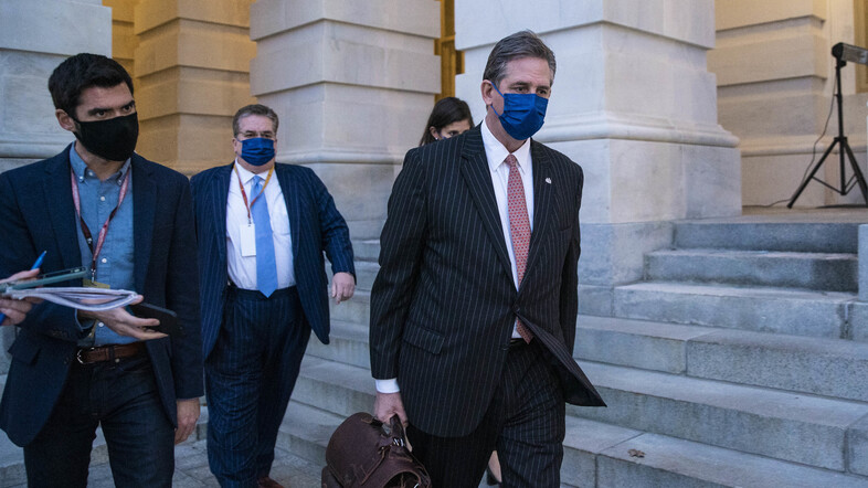 Bruce Castor, defense attorney for former President Donald Trump (center), departs the U.S. Capitol following the first day of the impeachment trial on Monday. (Sarah Silbiger/Getty Images)