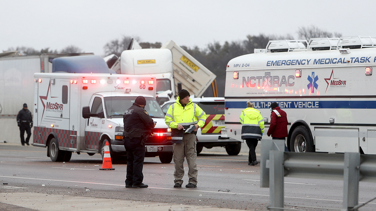 First responders arrive at the scene of a massive pile-up of vehicles on I-35W near downtown Fort Worth, Texas, on Thursday.