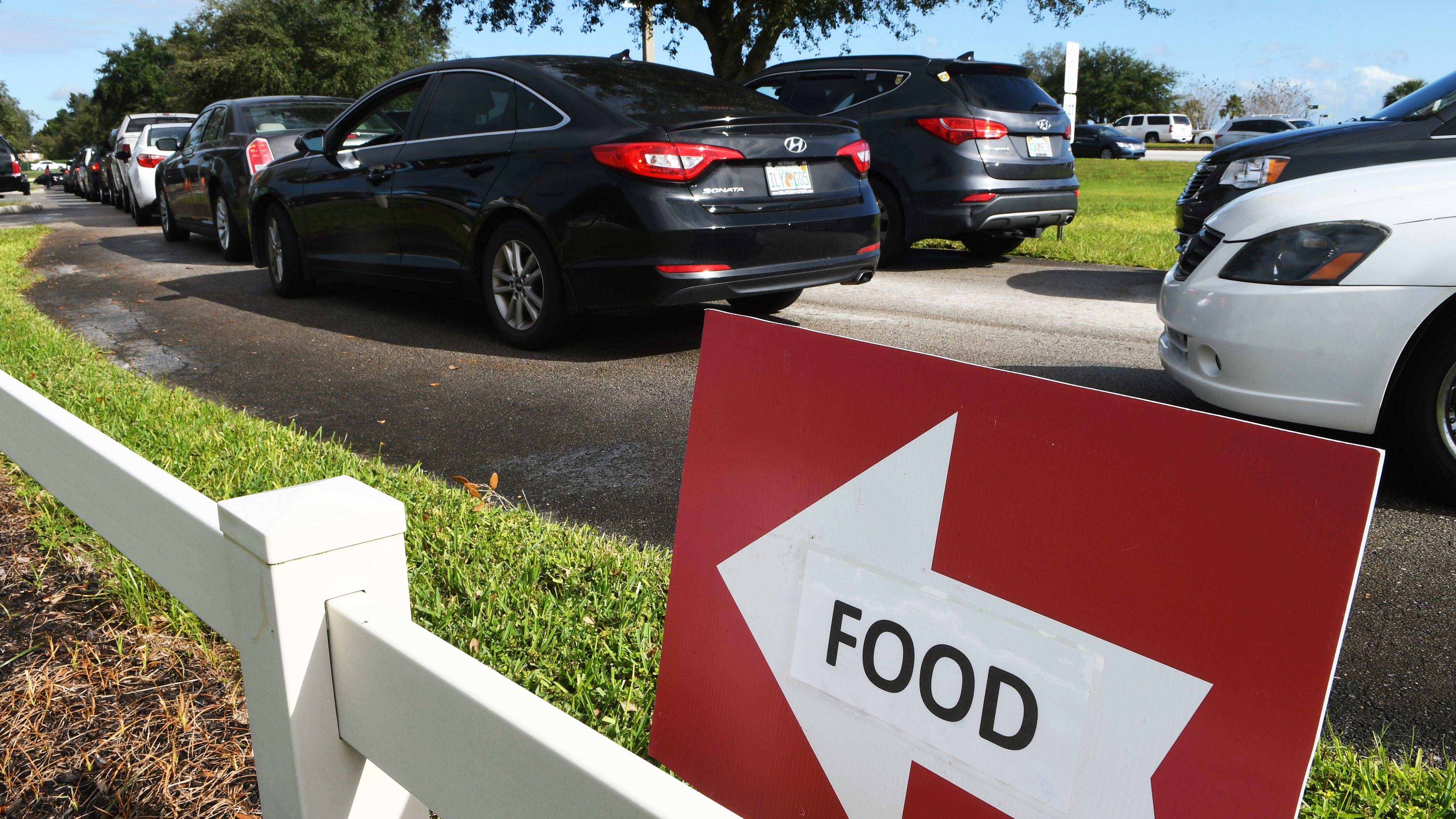 Residents line up in their cars at a food distribution site at Lake-Sumter State College in Florida last November. (SOPA Images/LightRocket via Getty Images)