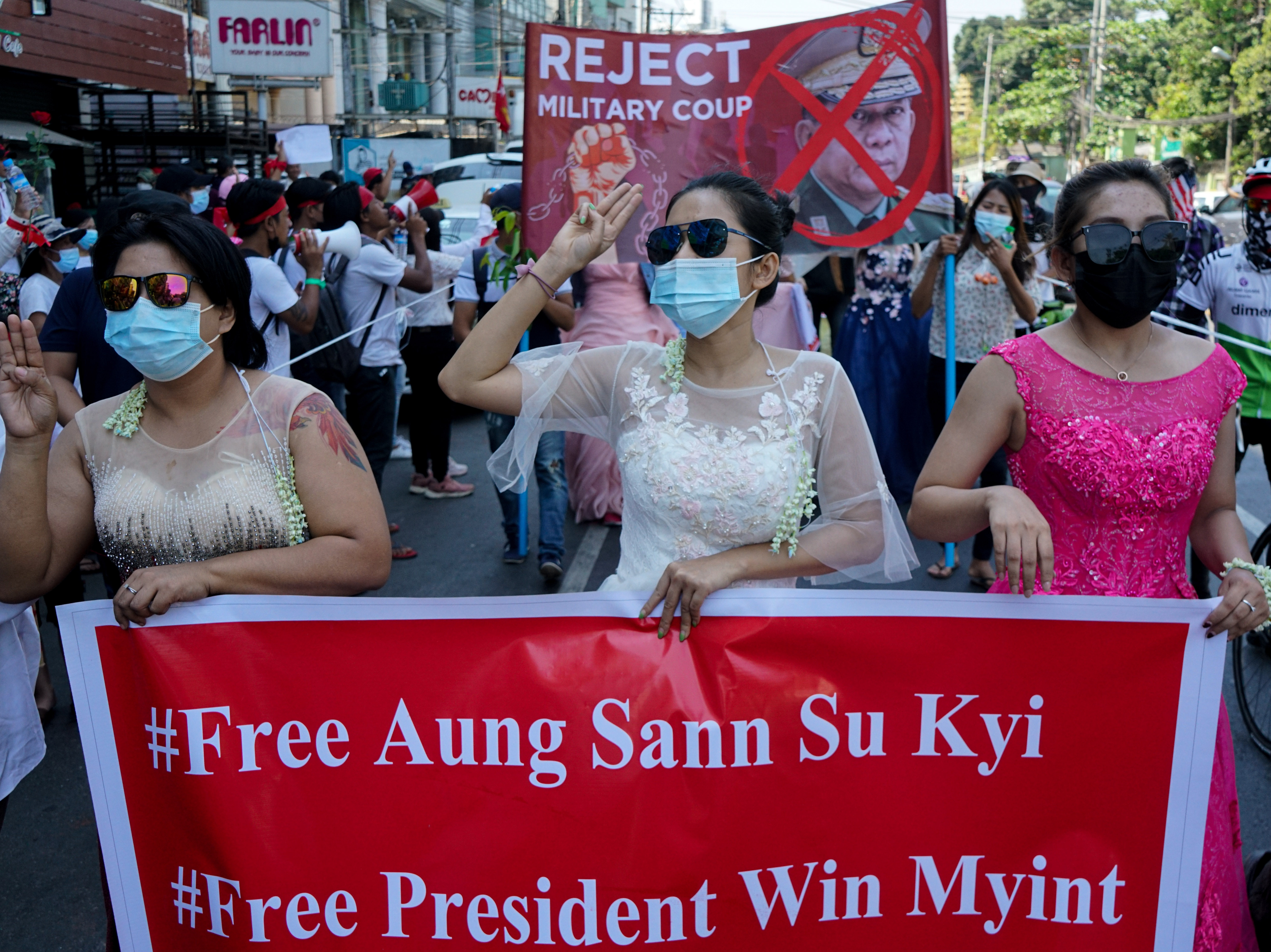 Women protest on Wednesday against the military coup that toppled the government led by Aung San Suu Kyi earlier this month. The Biden administration on Thursday announced sanctions against several of the coup leaders. (Anadolu Agency via Getty Images)
