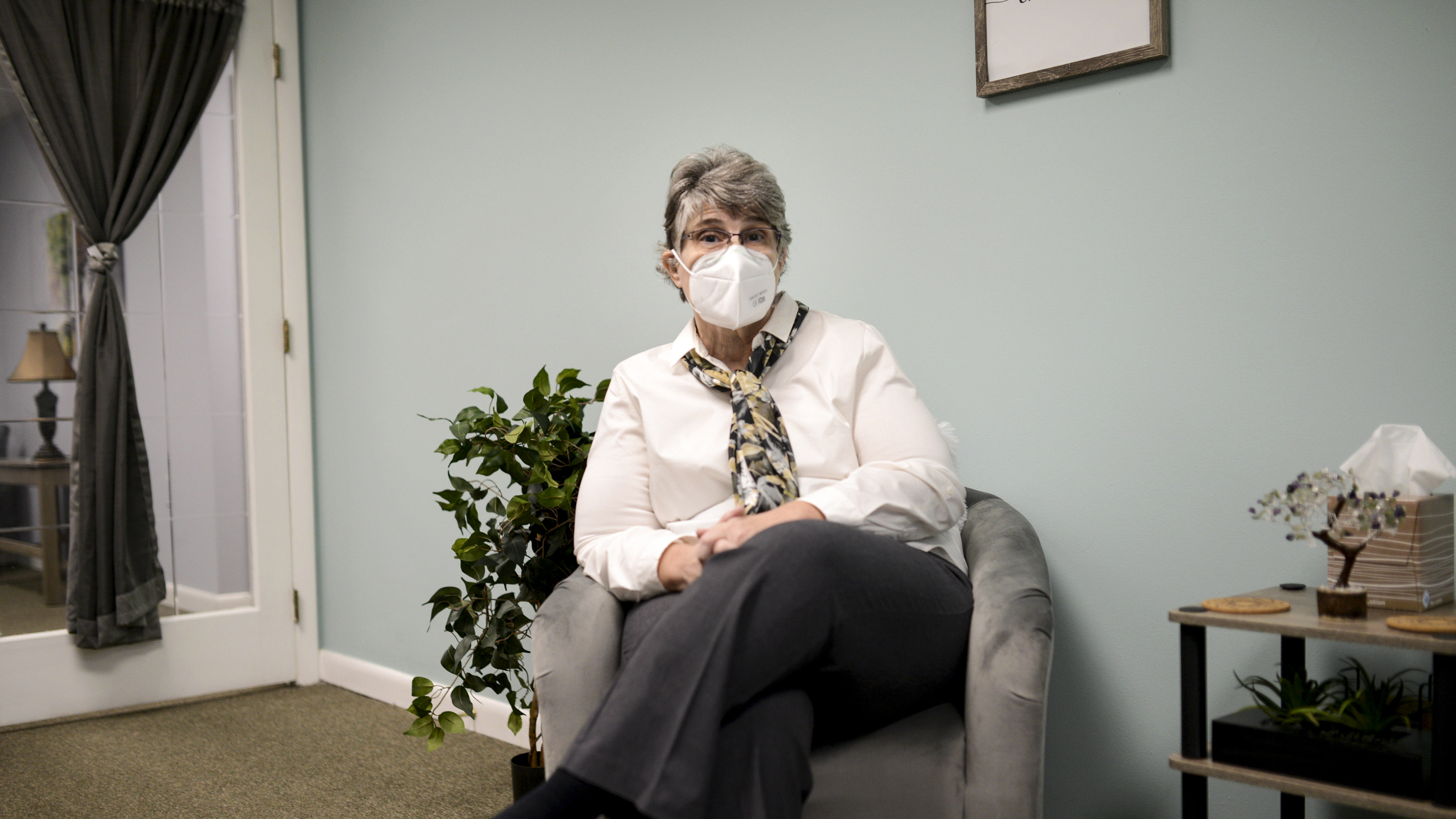 Jodee Pineau-Chaisson sits in her office in Springfield, Mass. on January 12, 2021. Pineau-Chaisson, a social worker, contracted the coronavirus last May and continues to have symptoms even months after testing negative for the virus.