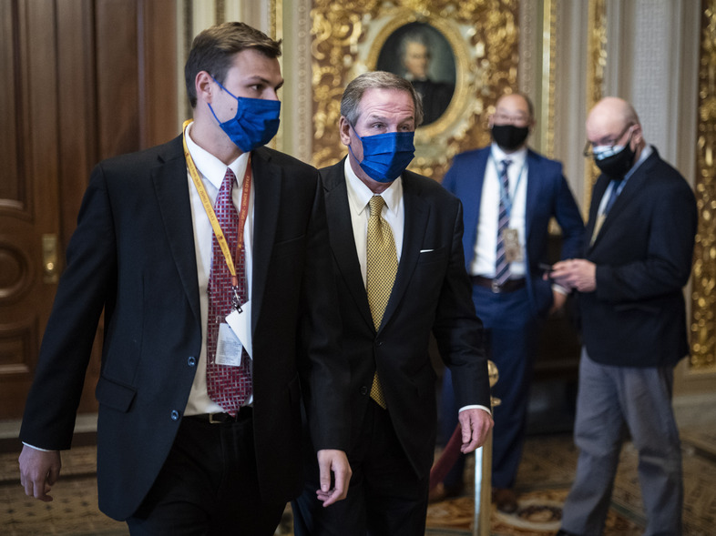 Michael van der Veen, lawyer for former President Donald Trump, walks to the Senate floor on the fourth day of the Senate impeachment trial, which had been expected to wrap up Saturday. (Jabin Botsford/AP)
