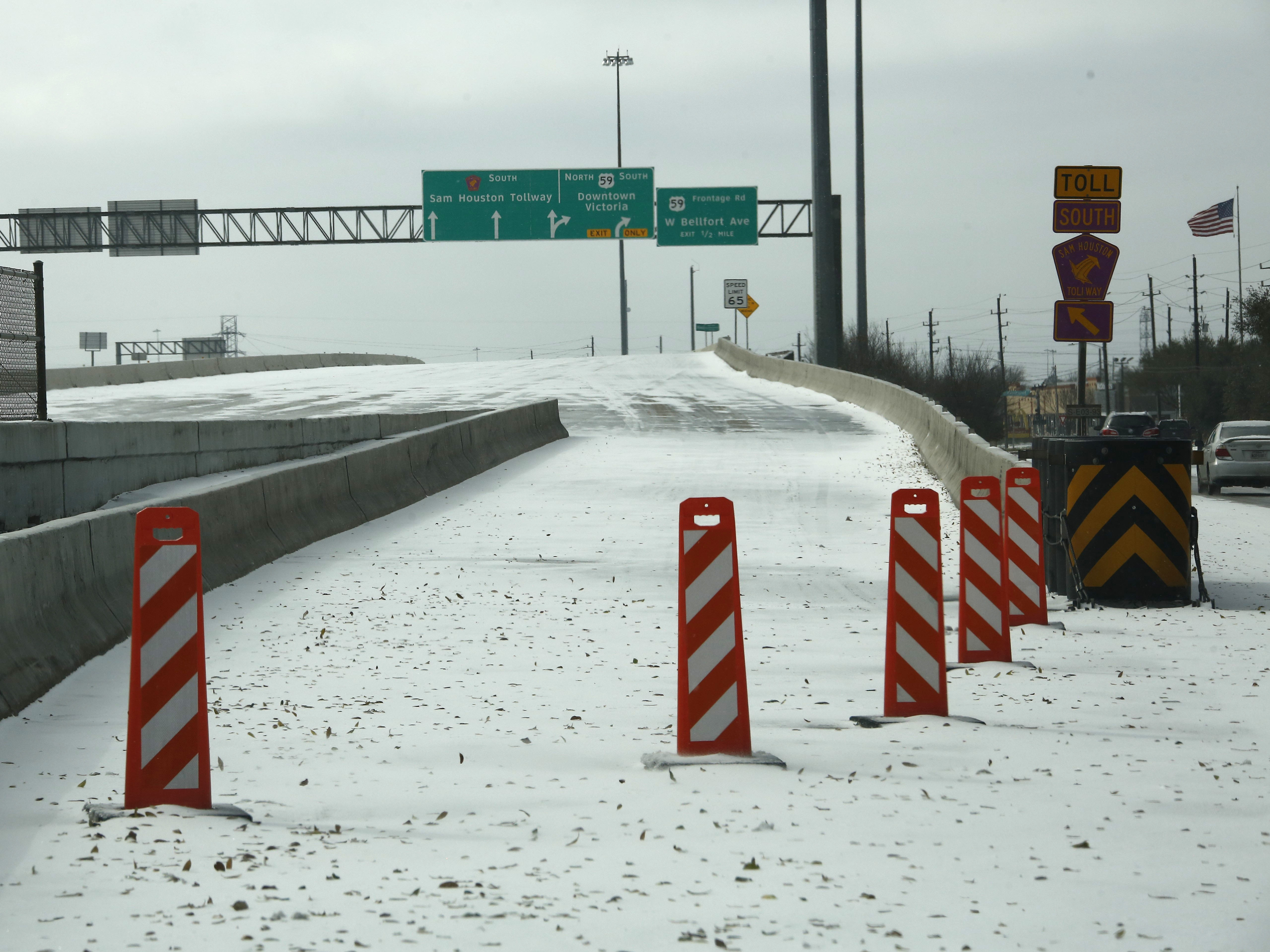 A highway on-ramp in Houston is closed due to snow and ice on Monday. Frigid temperatures, icy roads and power outages caused by a major winter storm have interfered with COVID-19 vaccine distribution in Texas and several other states. (Xinhua News Agency/Getty Images)