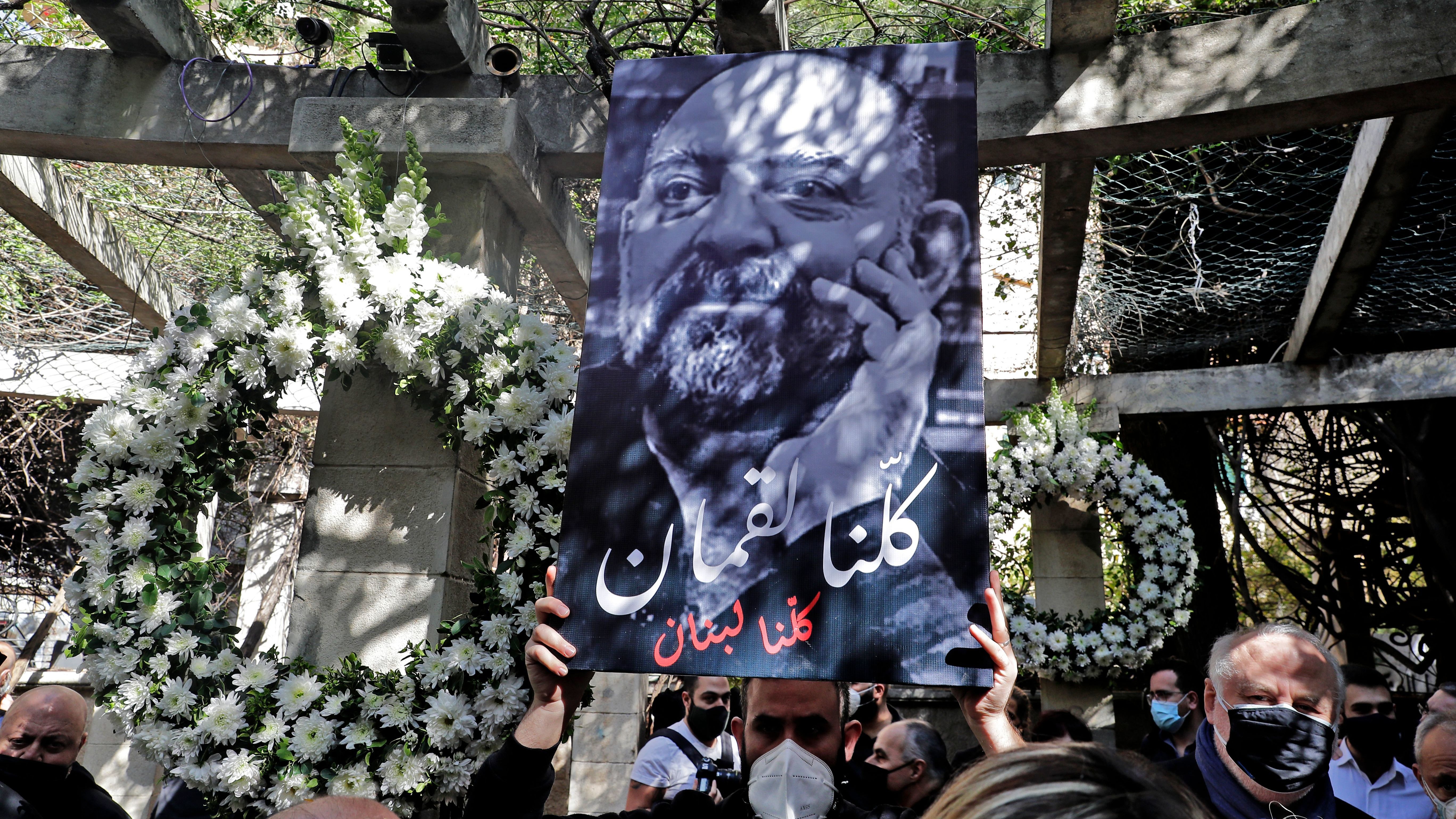 Friends and family members of slain prominent Lebanese activist and intellectual Lokman Slim (shown in the raised image), attend a memorial ceremony in the garden of the family residence in the capital Beirut