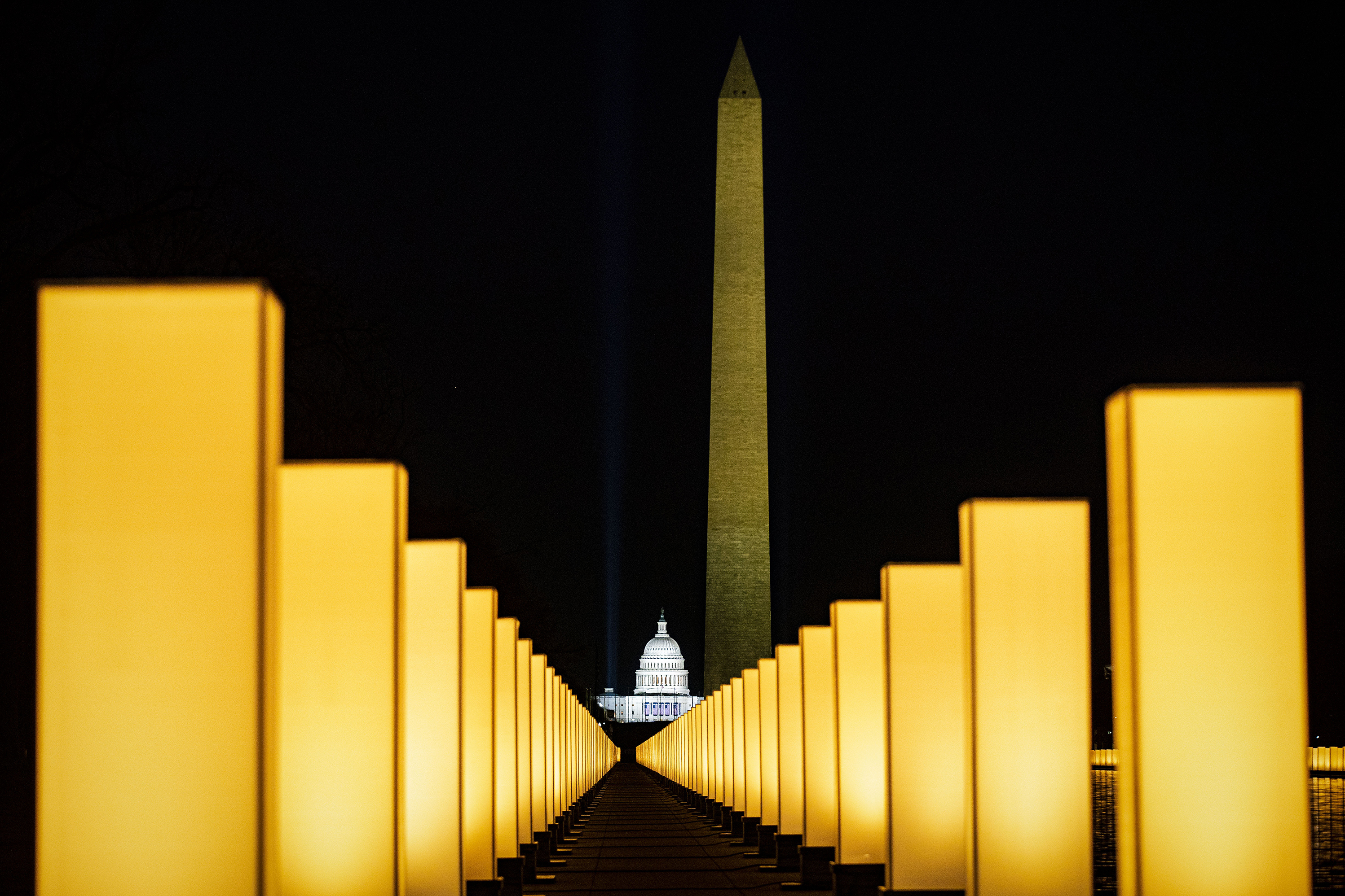 On Jan. 19, the incoming Biden administration hosted memorial to lives lost to COVID-19 at the Lincoln Memorial Reflecting Pool on the National Mall. Since then another 100,000 Americans have died. (Bloomberg via Getty Images)