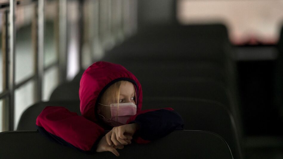 A first-grade student sits on the bus after a day of classes in Woodland, Wash., on Thursday. (Nathan Howard/Getty Images)