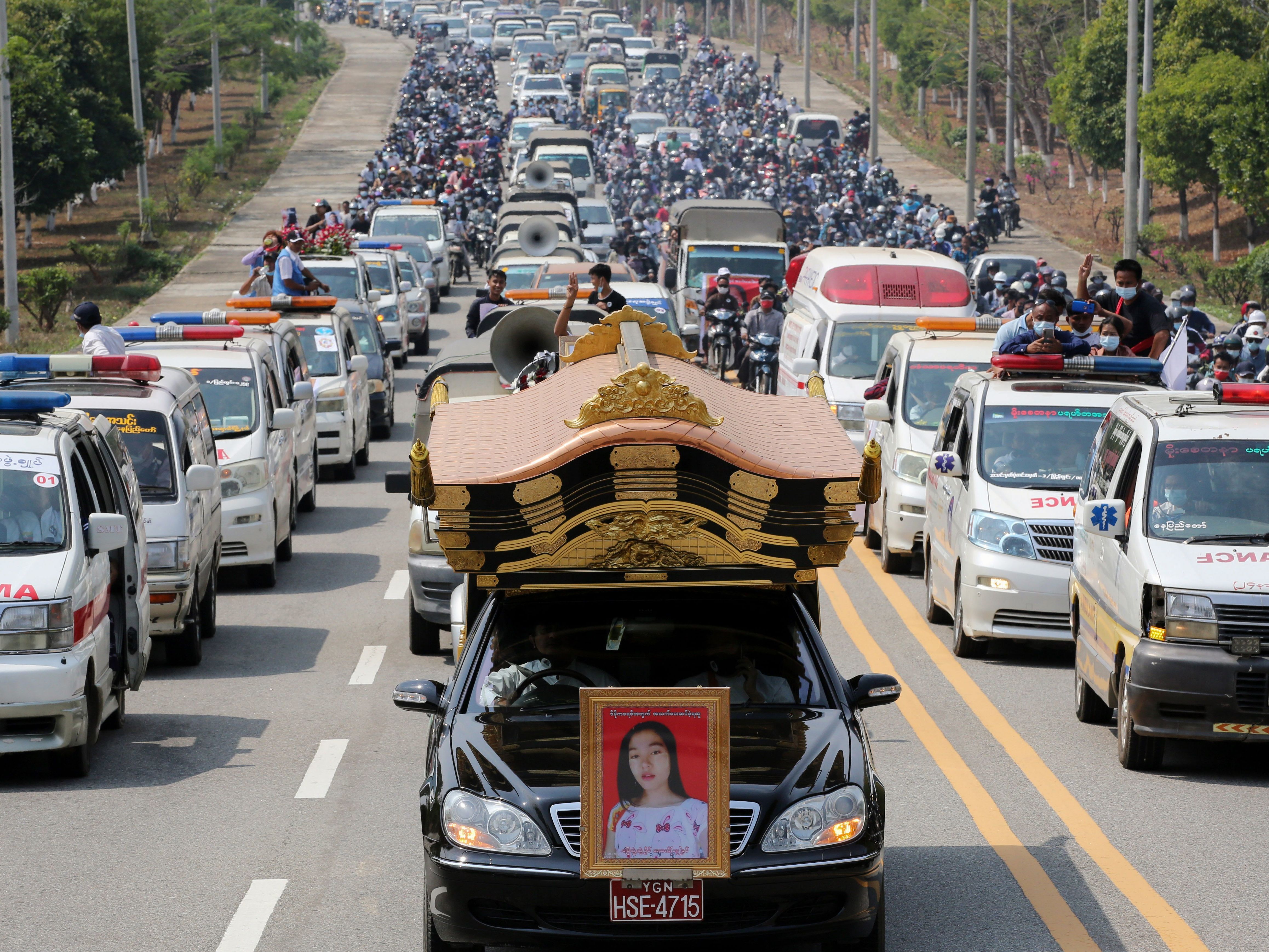 A car carrying the body of protester Mya Thwet Thwet Khine is pictured at the head of a convoy during her funeral service Sunday in Naypyitaw. She was the first confirmed fatality in the ongoing protests against the military coup. (AFP via Getty Images)