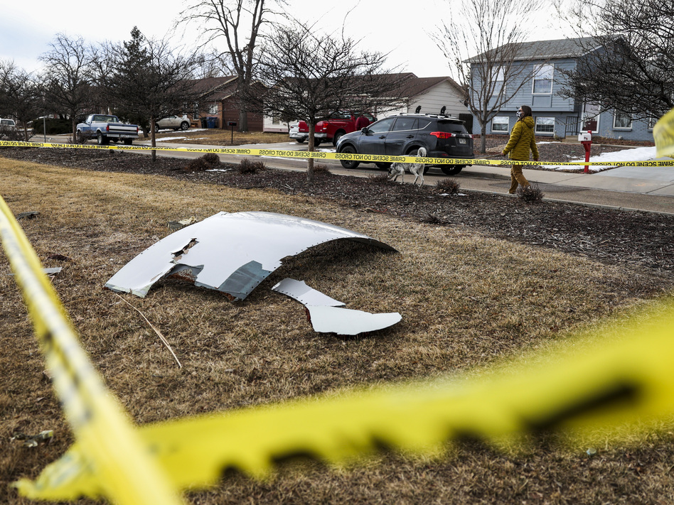 Pieces of an engine from United Airlines Flight 328 sit scattered in a neighborhood after the jet's engine failure on Saturday after takeoff from Denver. (Michael Ciaglo/Getty Images)