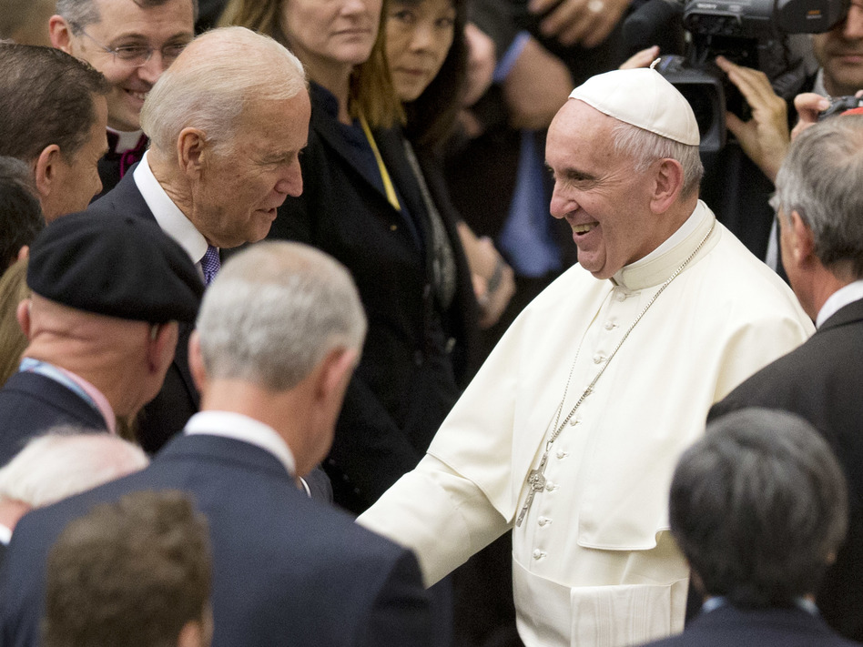 Pope Francis shakes hands with Joe Biden, then vice president, at the Vatican, in 2016. (Andrew Medichini/AP)