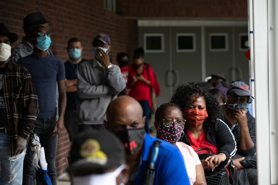 People wait in line on the first day of early voting for the 2020 general election on Oct. 12 in Atlanta. (Jessica McGowan/Getty Images)