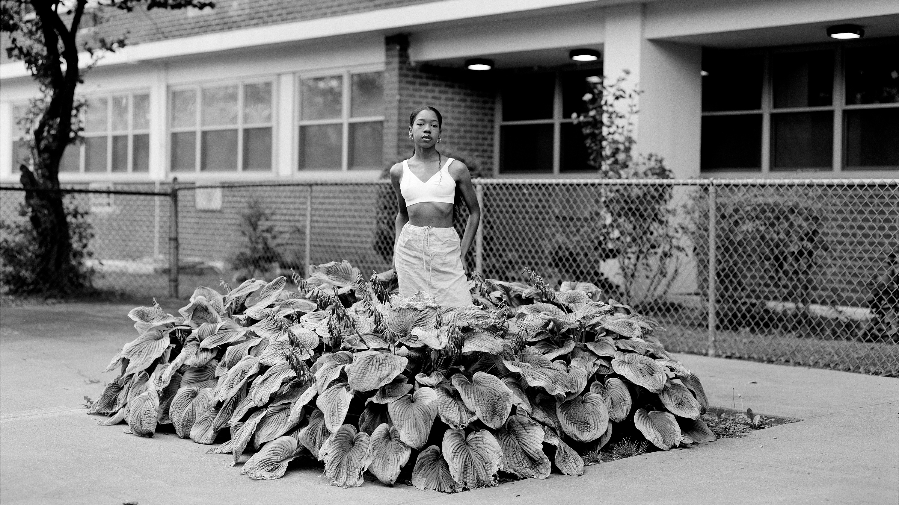 Chanell Stone photographs places like overgrown lots and green spaces at public housing projects, often including herself in the frame. Above, "In search of a certain Eden," 2019, Brooklyn.