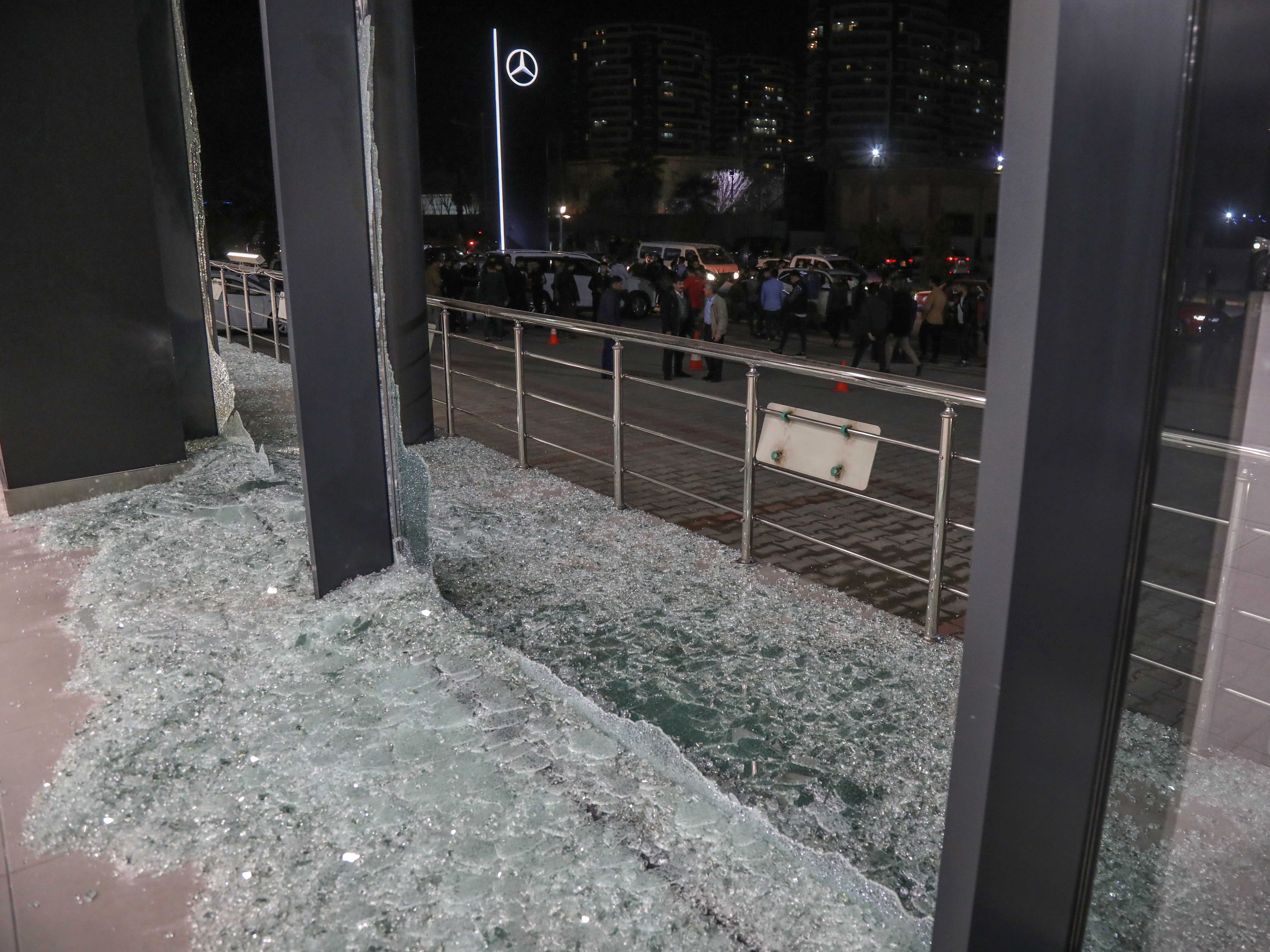 Shattered glass is on the ground following a rocket attack in Irbil, the capital of the northern Iraqi Kurdish autonomous region, on Feb. 15. On Thursday, the U.S. launched airstrikes targeting Iranian-backed groups in eastern Syria in response to recent attacks against Americans in Iraq. (AFP via Getty Images)