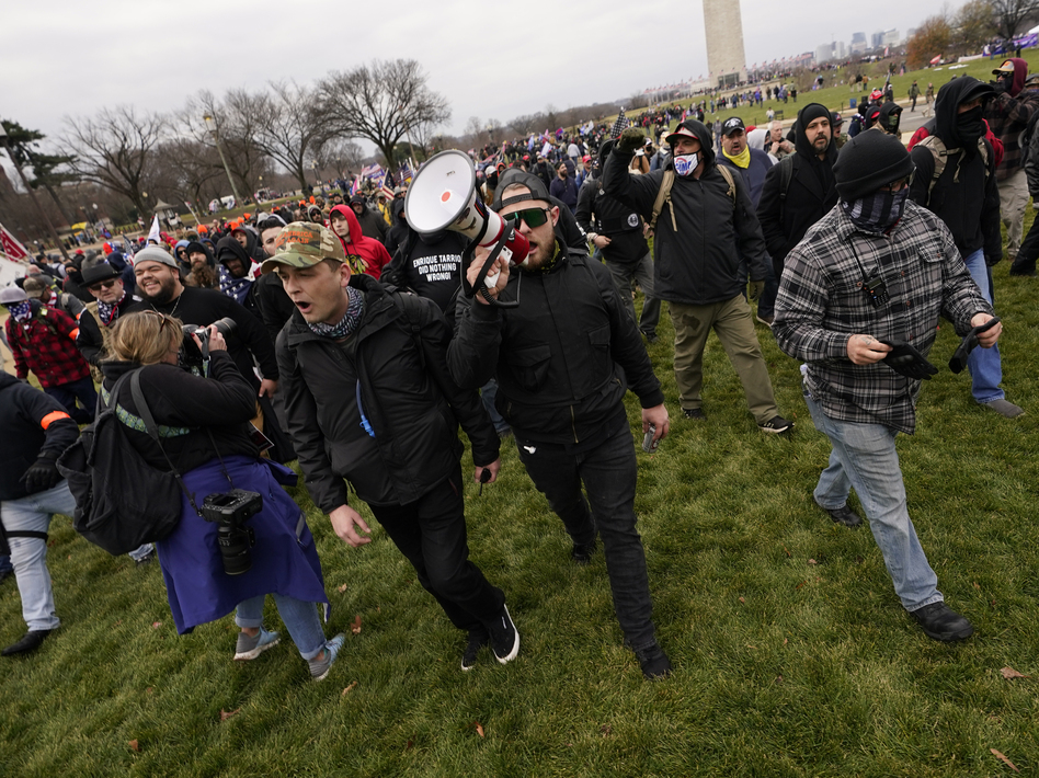 Ethan Nordean, with bullhorn, leads members of the far-right group Proud Boys before the riot at the U.S. Capitol on Jan. 6. The self-described sergeant-at-arms of the Seattle Proud Boys is facing federal charges over his role in the attack. (Carolyn Kaster/AP)