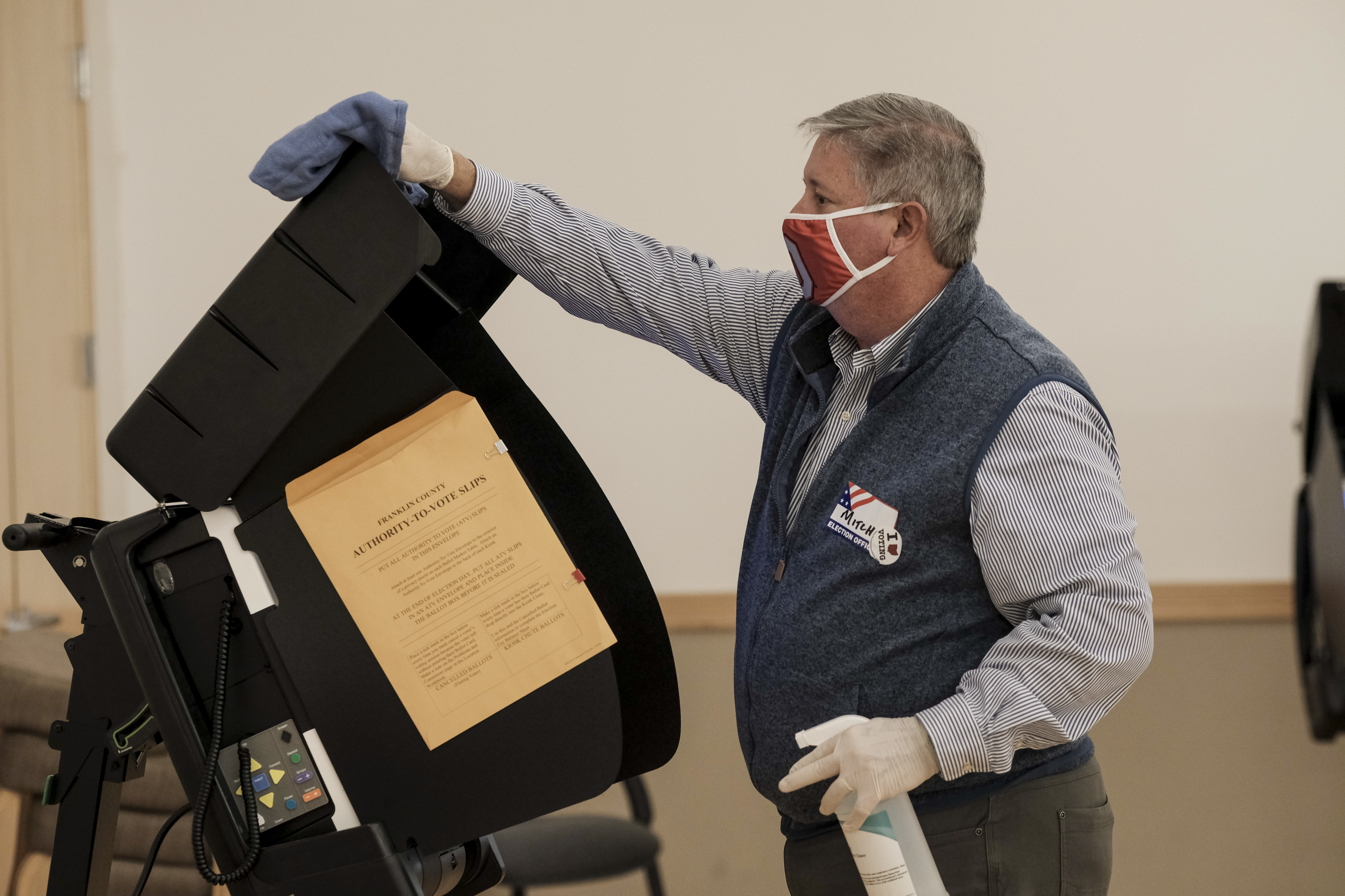 A poll worker sanitizes a voting machine on Nov. 3, 2020 in Columbus, Ohio. Conspiracy theories floated by former President Donald Trump about equipment made by Dominion Voting Systems has led local officials in one Ohio County to slow down the purchase of new Dominion machines. (Getty Images)