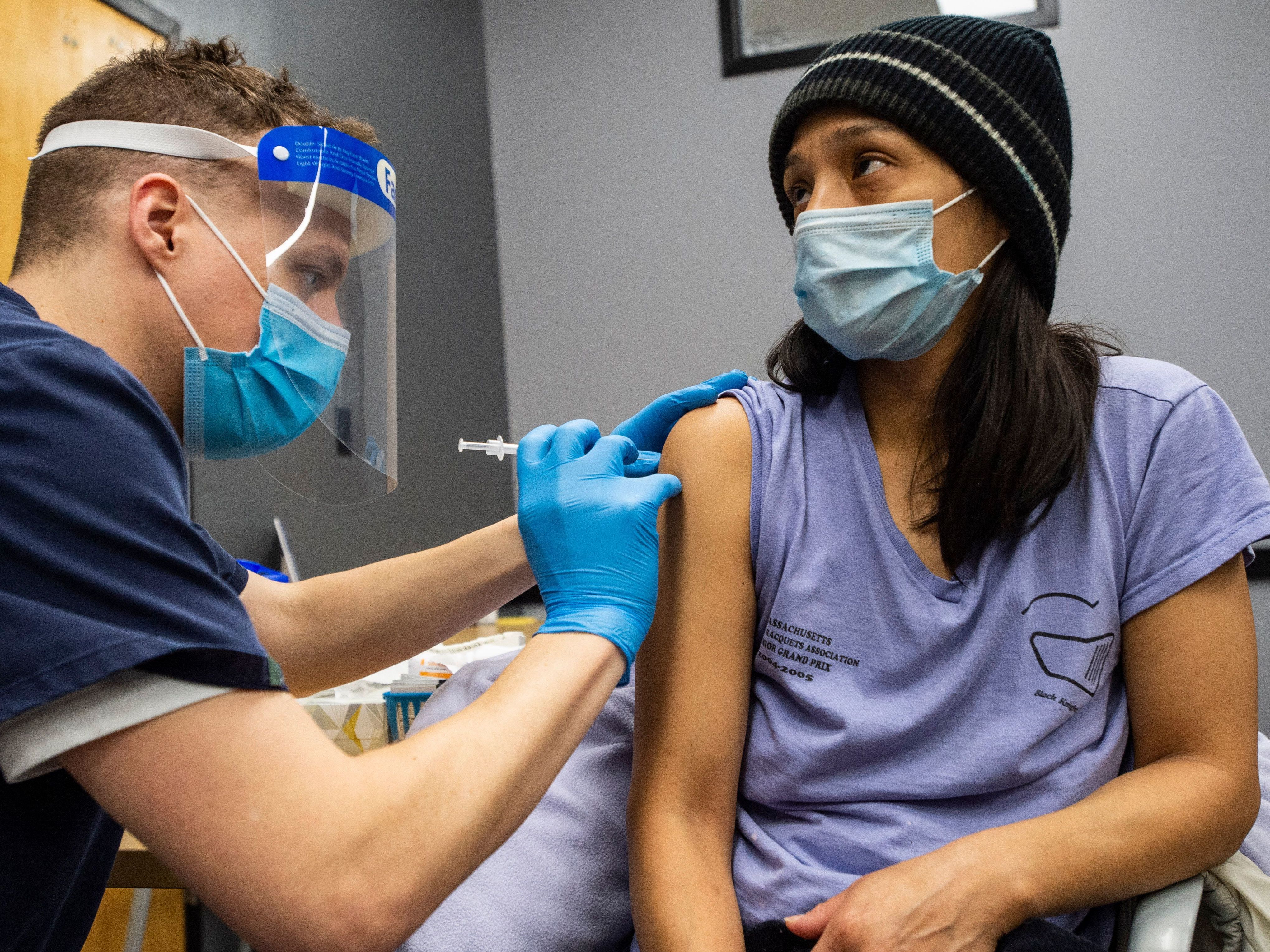 Edith Arangoitia receives a COVID-19 vaccination in Chelsea, Mass., a heavily Hispanic community, on Feb. 16. (AFP via Getty Images)