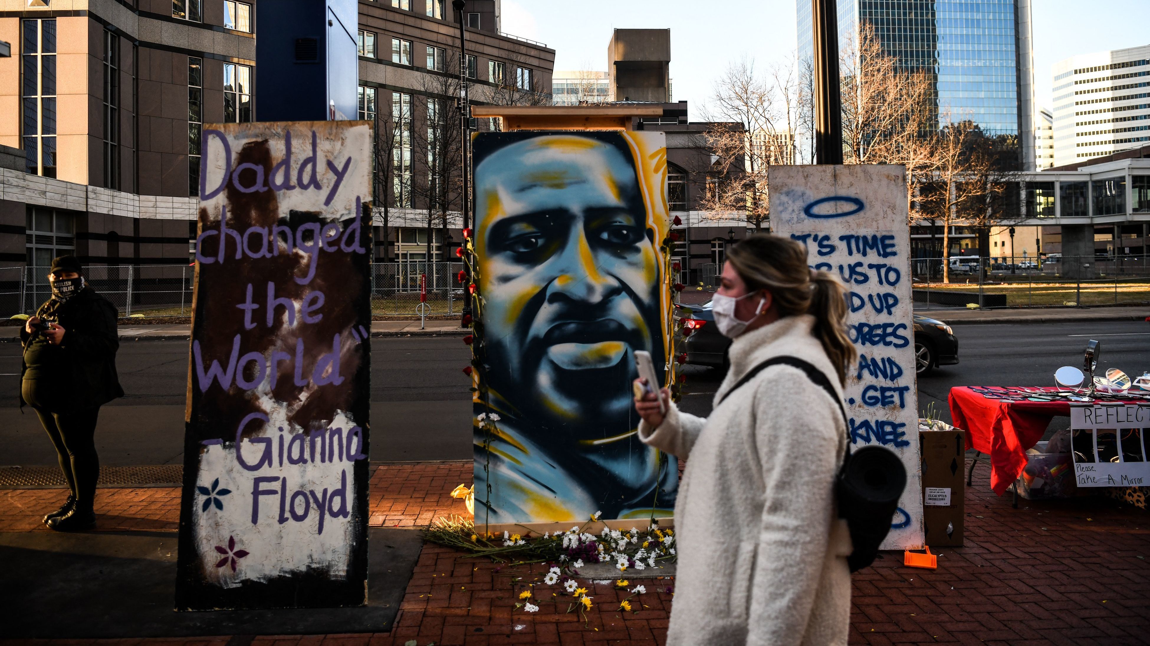 Hennepin County Judge Peter Cahill sent potential jurors in Derek Chauvin's trial home on Monday. Here, a painting of Floyd is seen outside the Hennepin County Government Center, where the trial is taking place. (AFP via Getty Images)
