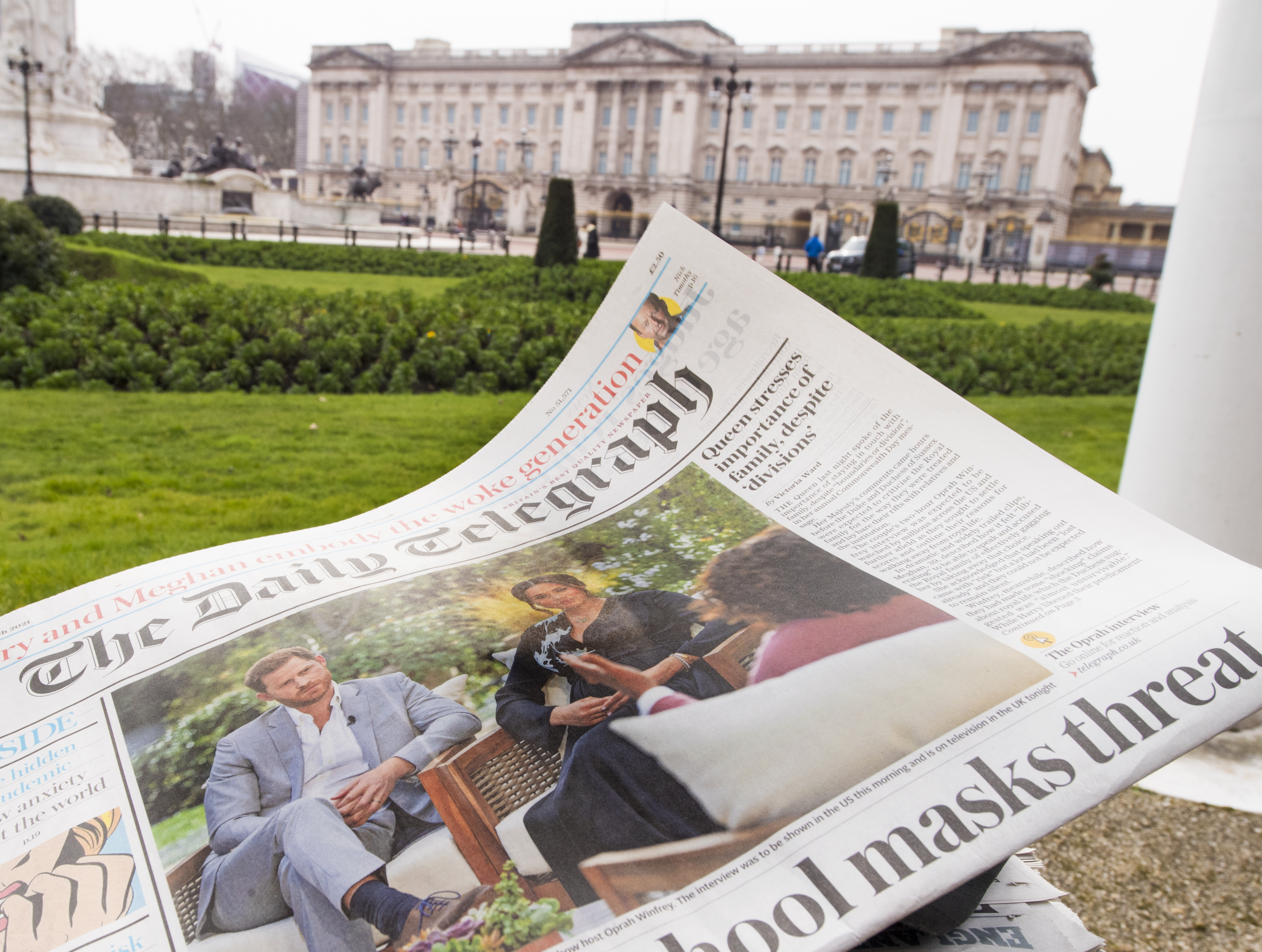 A British newspaper flutters in the wind outside Buckingham Palace in London the day after the Duke and Duchess of Sussex's interview with Oprah Winfrey. (PA Images via Getty Images)