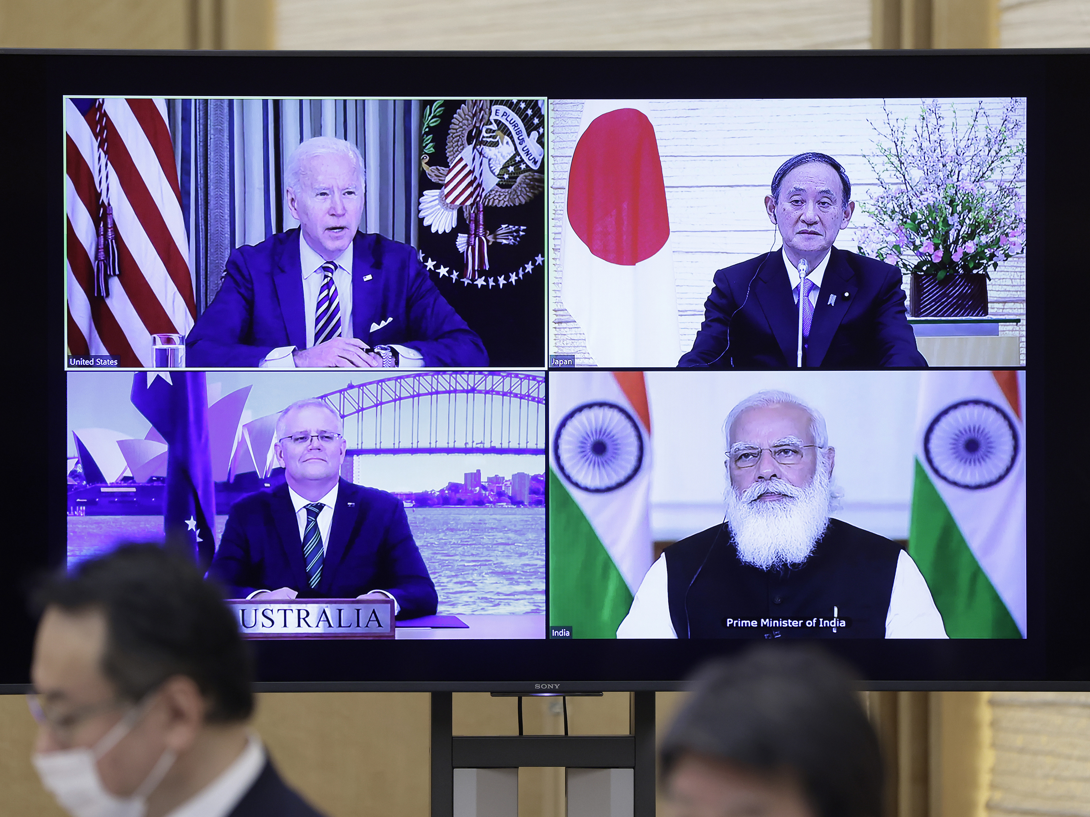 President Biden (clockwise from top left), Japanese Prime Minister Yoshihide Suga, Indian Prime Minister Narendra Modi and Australian Prime Minister Scott Morrison participate in the virtual Quadrilateral Security Dialogue or Quad meeting on Friday. (Bloomberg via Getty Images)