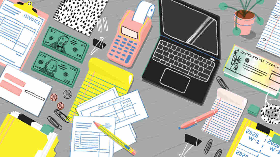 Illustration of a tabletop covered with tax-related items — an open laptop, money, W-2 forms, 1099-G forms, invoices, paperclips, pens, folders, paper, a glass of water and a plant. The illustration is overhead and the colors are bold pastels — bright yellow, peach, gray, black, white, baby blue and a sage green.