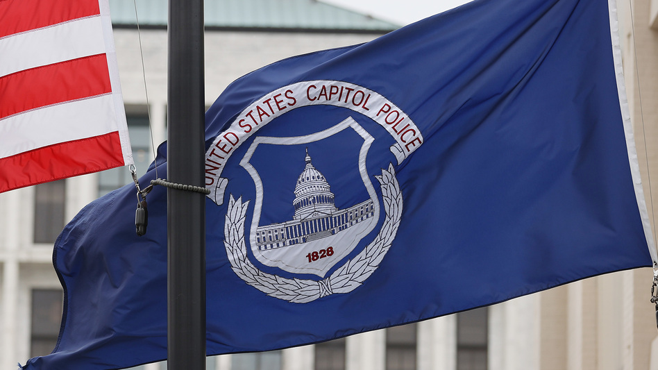 The U.S. flag and the U.S. Capitol Police flag were flown at half-staff after the death of Capitol Police officer Brian Sicknick. On Sunday, the FBI arrested two men who are accused of spraying chemicals on Sicknick and others during the Jan. 6 Capitol riot. (Chip Somodevilla/Getty Images)