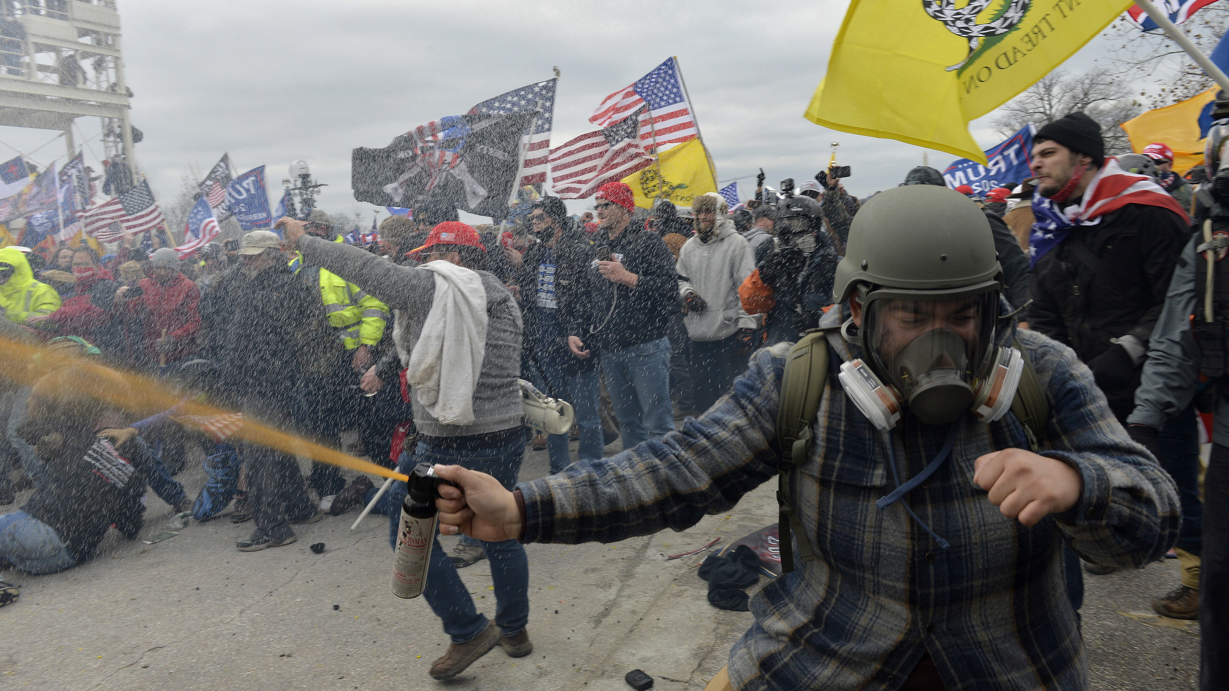 Pro-Trump extremists clashed with police during the storming of the U.S. Capitol on Jan. 6. The rioters may not have fired shots, but many were armed with other weapons, court documents show. (AFP via Getty Images)