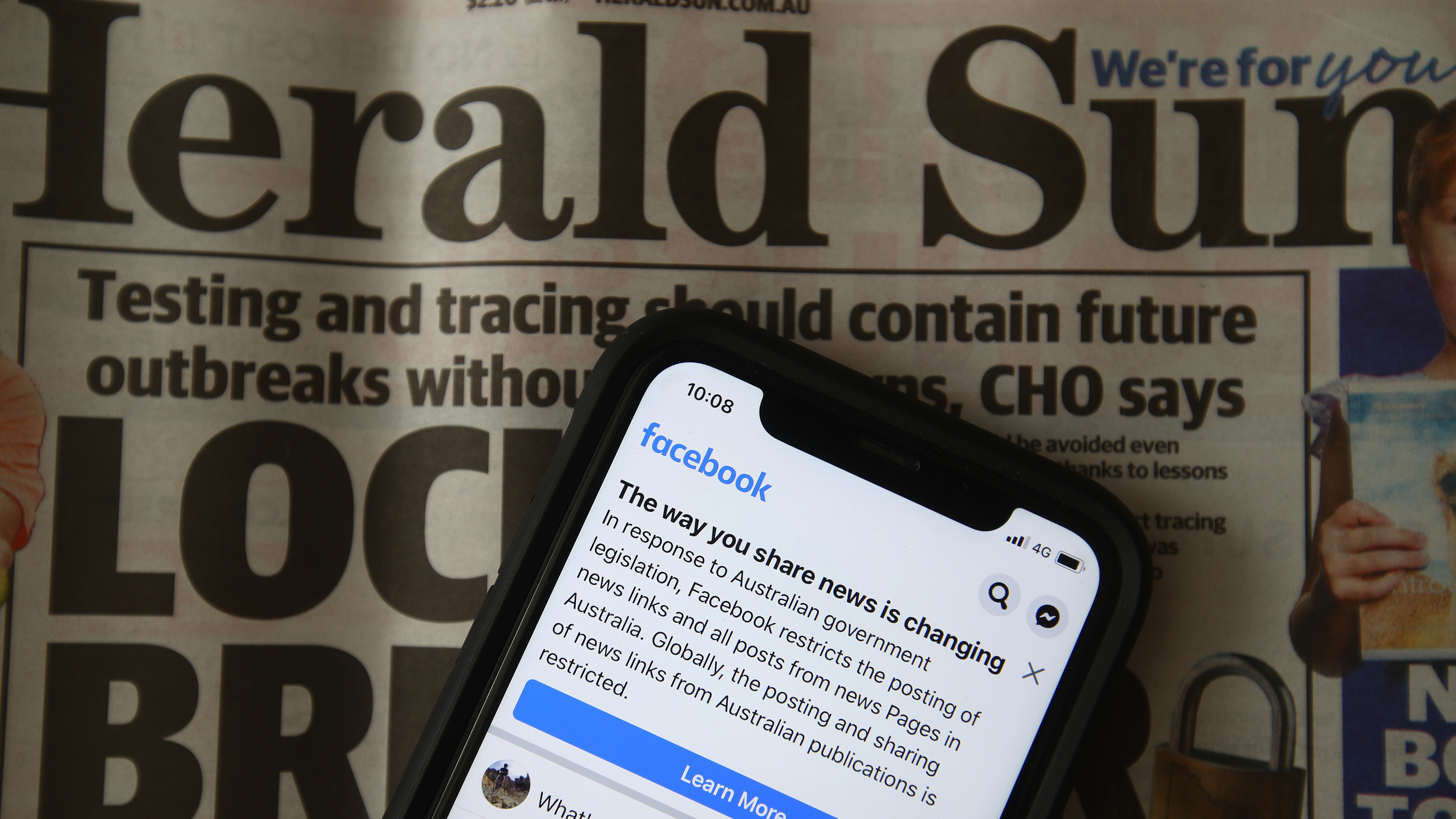 An illustration of a message seen on Facebook mobile last month, when Facebook banned publishers and users in Australia from posting and sharing news content in a dispute over a new law requiring tech platforms to pay for it. (Getty Images)