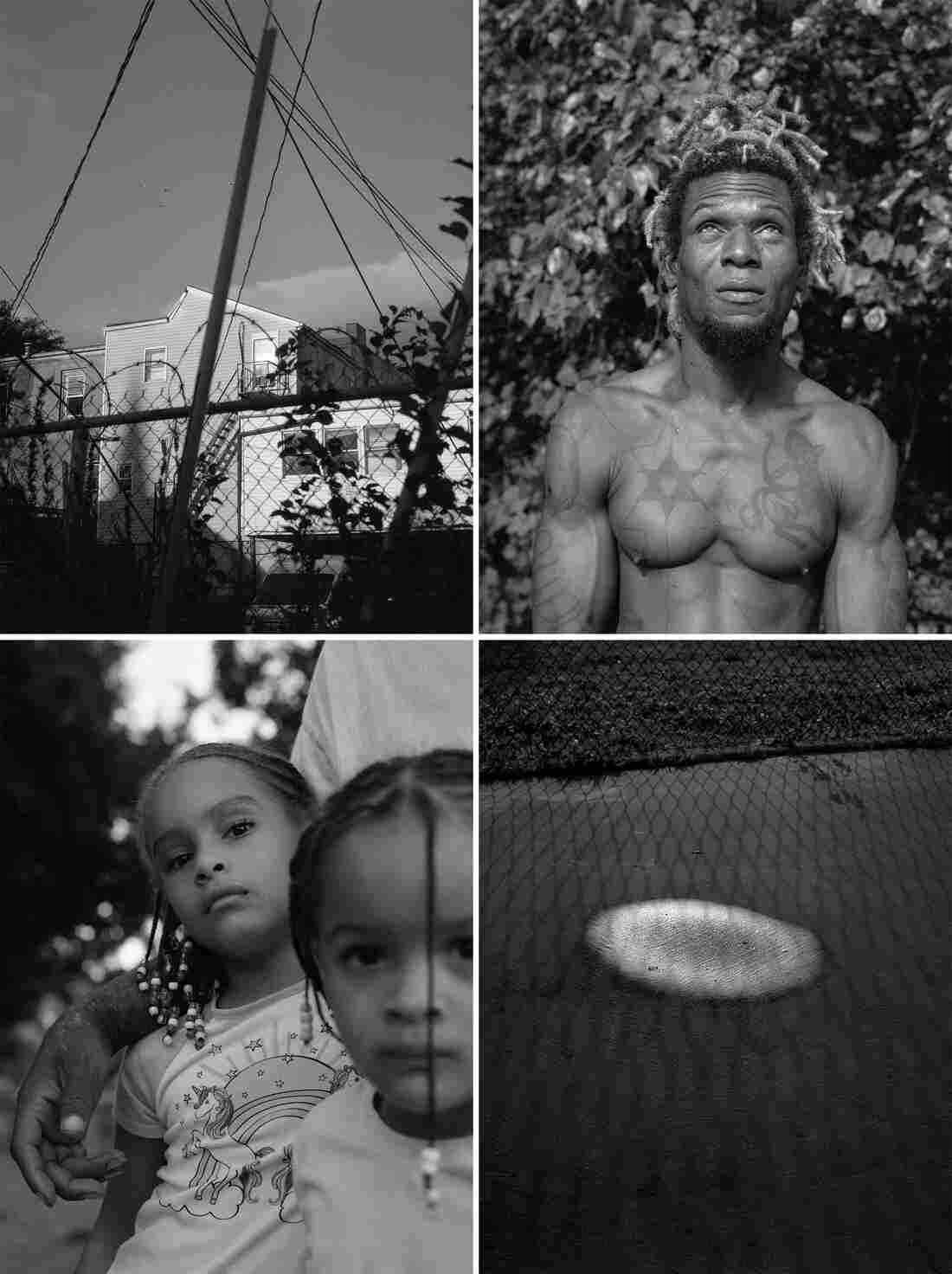 A fence in front of homes, a shirtless Black man with tattoos, a chain link fence casts a shadow over a puddle, two young Black girls. All photographs are in black and white.