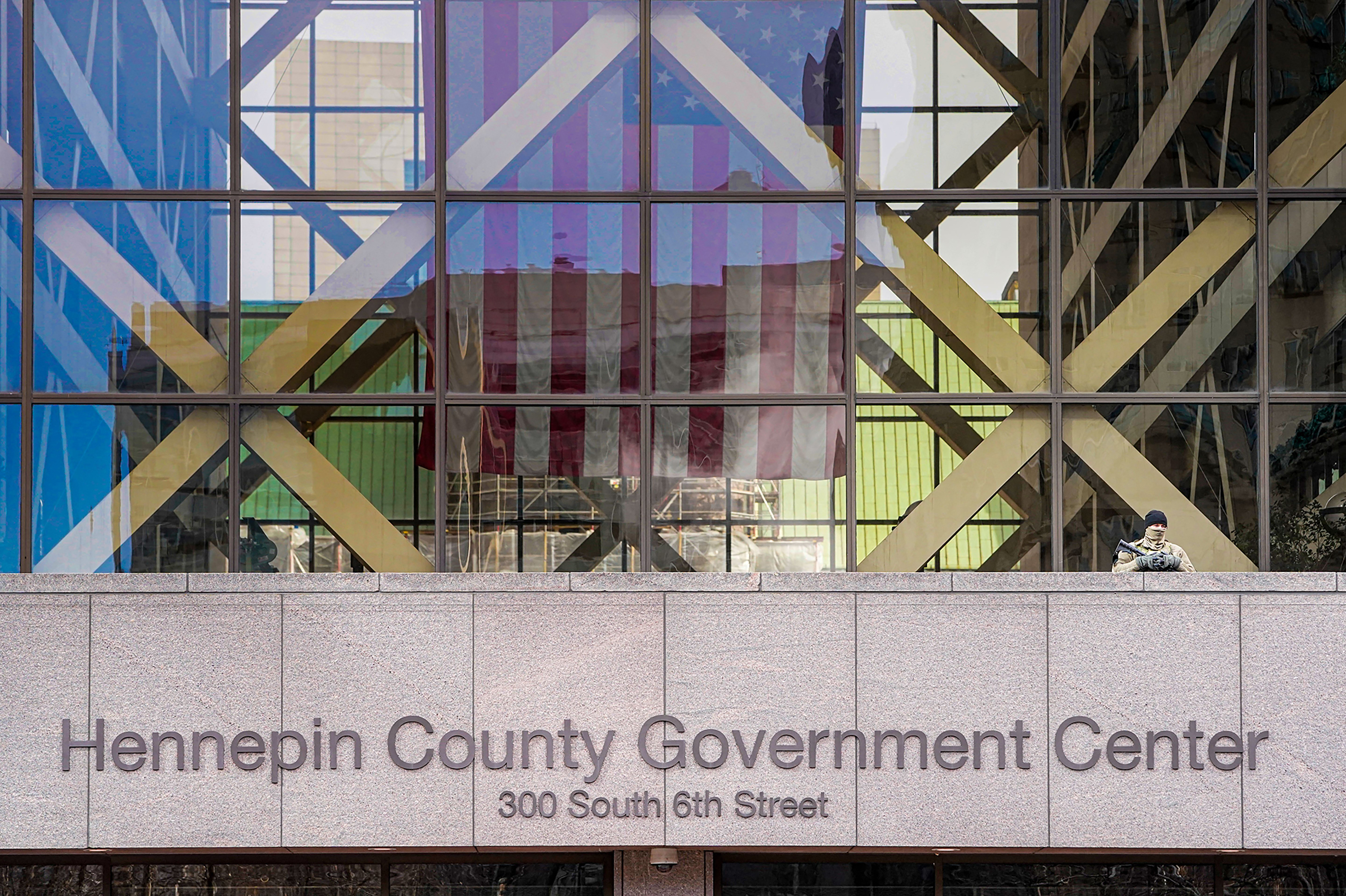 A member of the Minnesota National Guard stands outside the Hennepin County Government Center during jury selection in the trial of former Minneapolis police officer Derek Chauvin on March 11 in Minneapolis. Chauvin is facing murder charges in George Floyd's death. Among the 12 jurors and three alternates selected are three Black men, one Black woman and two multiracial jurors. (AFP via Getty Images)