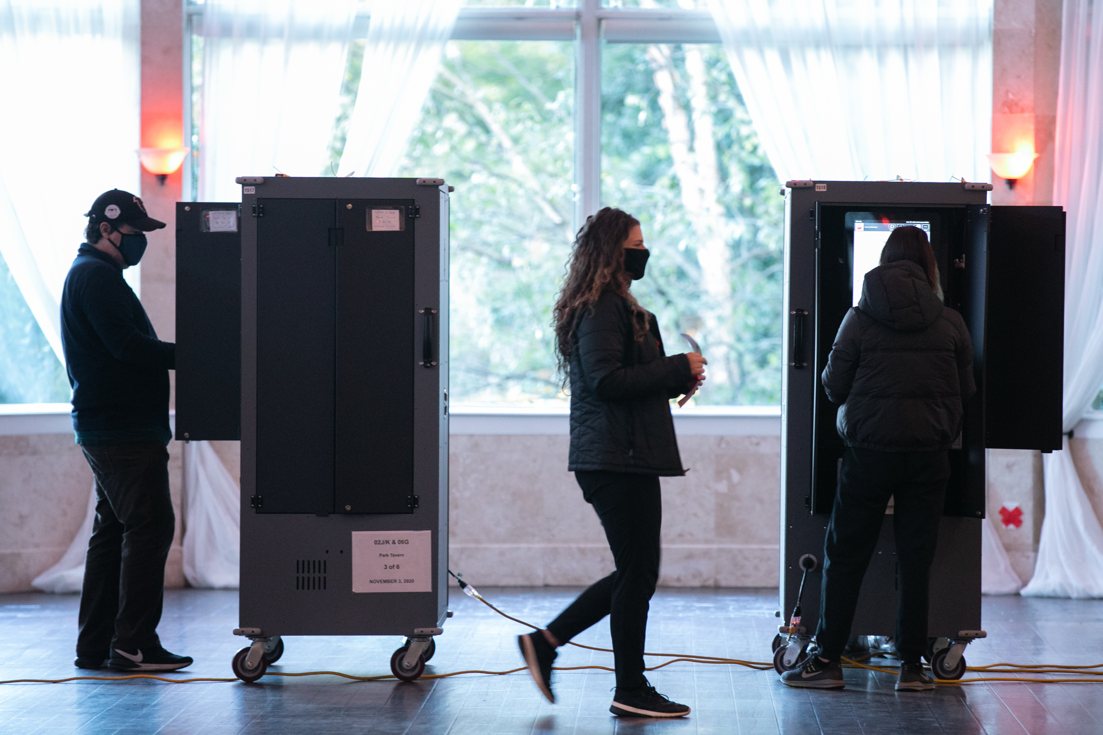 Voters in Atlanta casting their ballots on voting equipment made by Dominion Voting Systems. After losing the election, former President Trump and his allies spread conspiracy theories about the company, which has responded with defamation suits to combat the disinformation. (Getty Images)