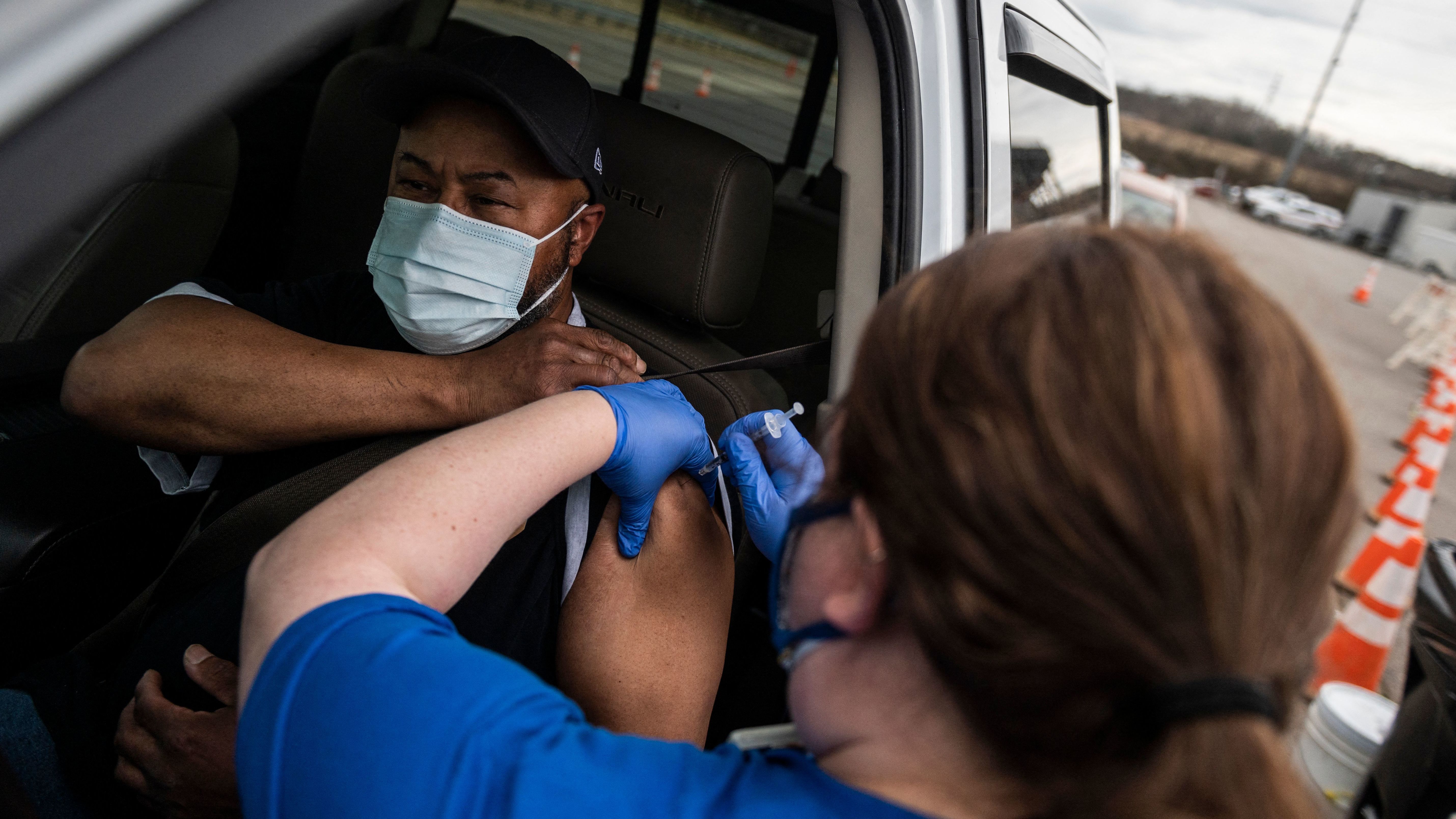 A nurse administers a shot at a COVID-19 mass vaccination site at Martinsville speedway in Ridgeway, Va., on March 12. Ashish Jha, a public health policy researcher, noted Sunday that "despite phenomenal vaccination rates, variants pulled ahead this week."