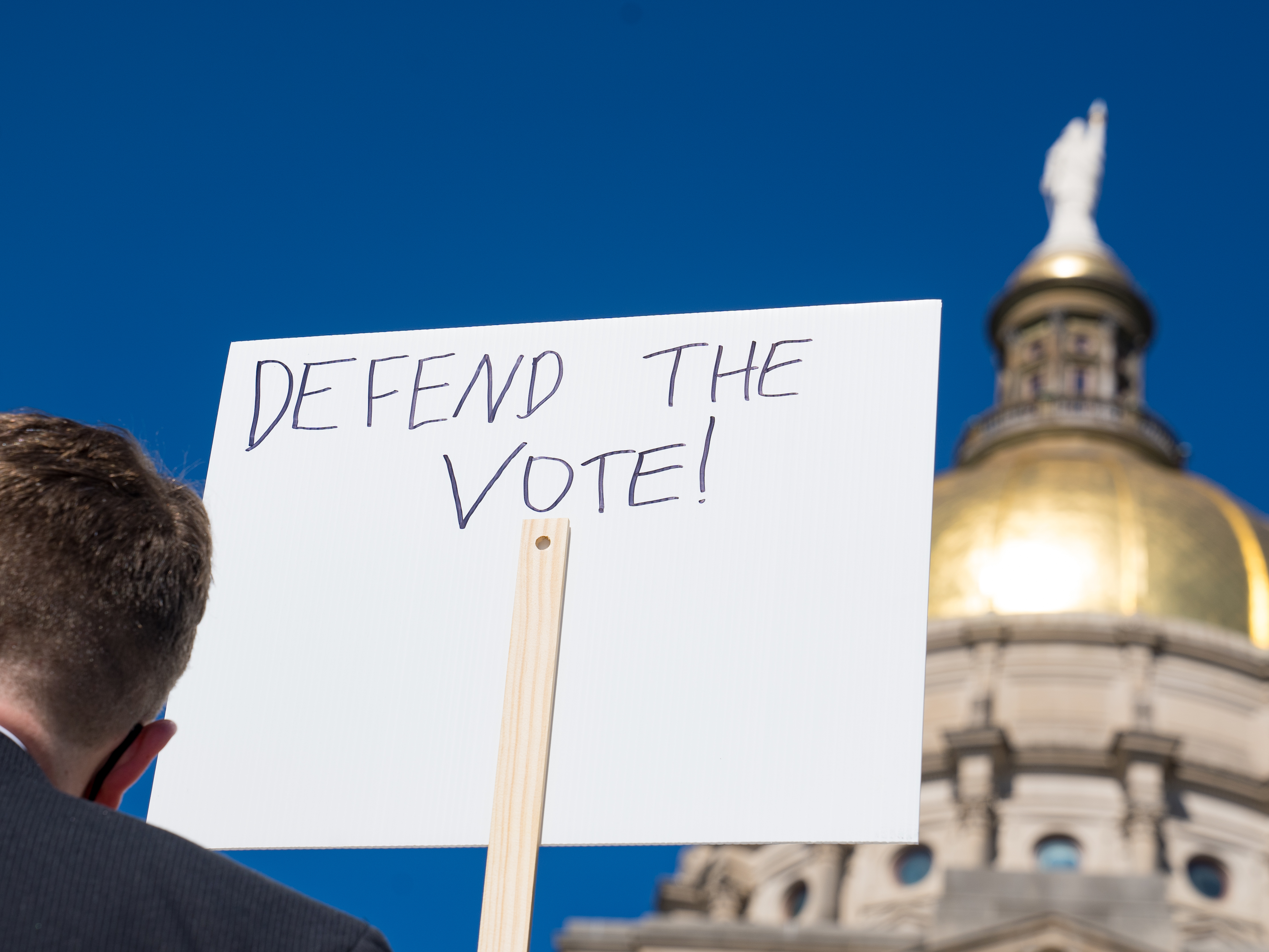 Demonstrators protest House Bill 531 last month in Atlanta. The legislation signed into law has drawn criticism from voting rights activists and businesses, who say it limits access to the polls and disproportionately harms voters of color. (Getty Images)