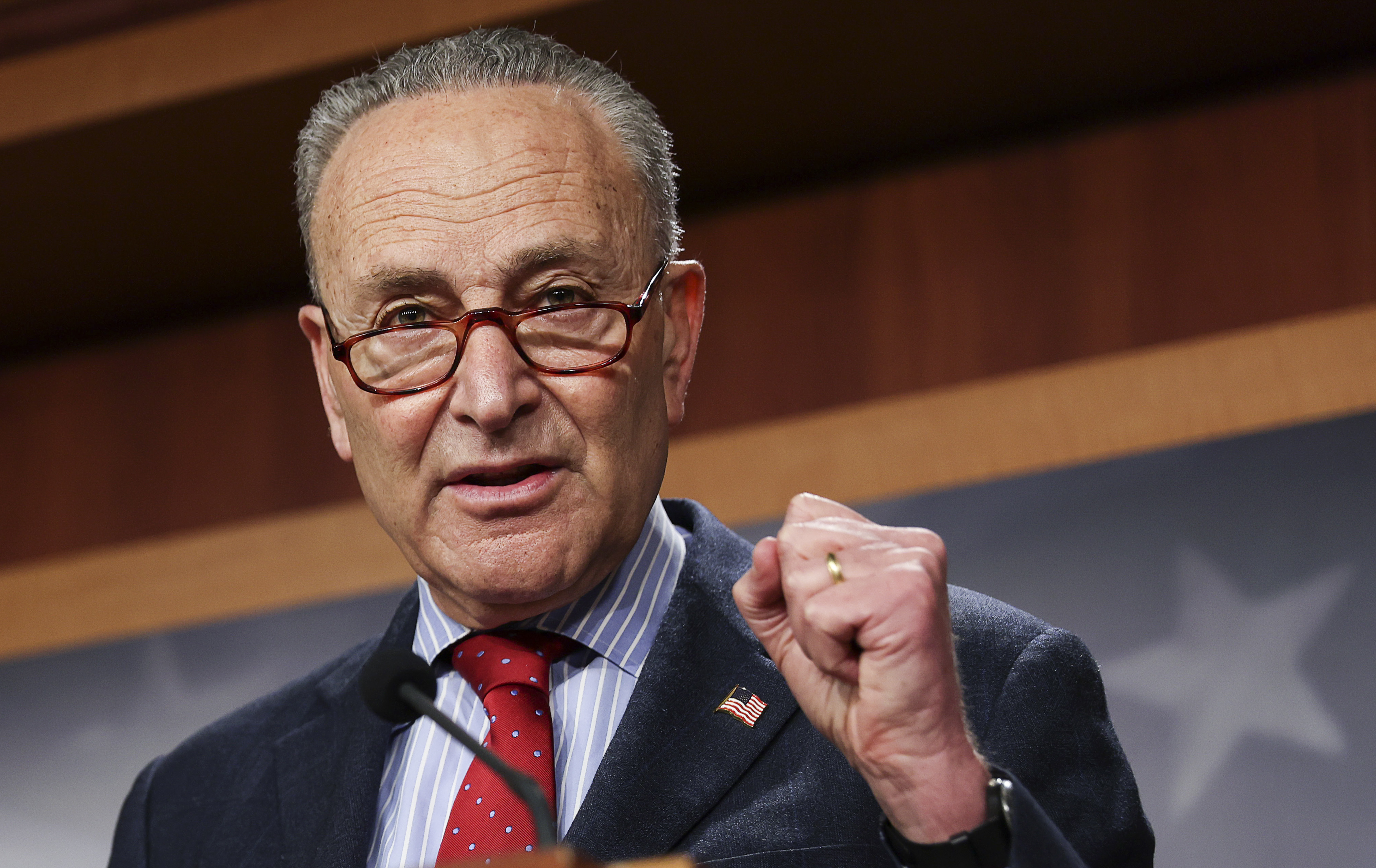 Senate Majority Leader Chuck Schumer, D-N.Y., speaks to the media on March 25. (Pool/Getty Images)