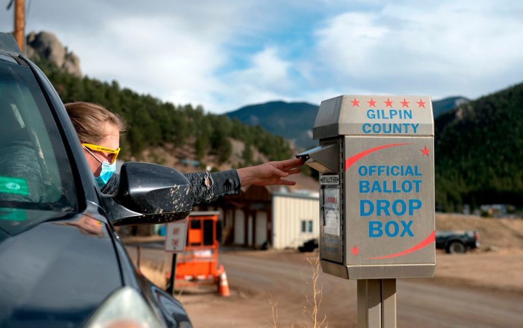 A voter drops off her ballot for the U.S. presidential election in November, in Rollinsville, Colo. Colorado's voting laws got fresh attention this week after the MLB decided to move its All-Star game to the state to protest Georgia's new legislation. (AFP via Getty Images)