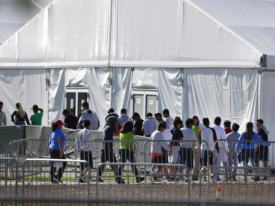 Children line up in February 2018 to enter a tent at the Homestead Temporary Shelter for Unaccompanied Children in Homestead, Fla. Many of these kids were taken from their parents after crossing the border illegally.