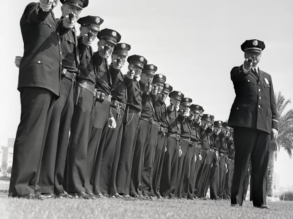 A line of policeman take aim. (Bettmann Archive)