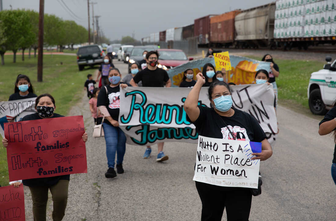 Protestors unfurl 'No ICE, No prisons, No More Cages' banner over