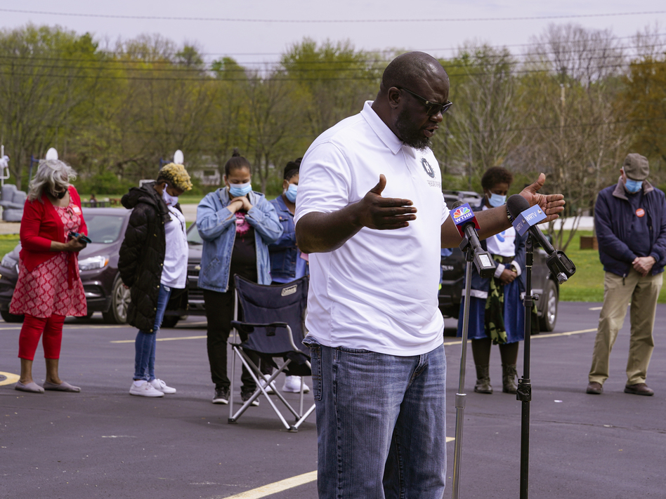 Pastor Denell Howard leads a prayer Saturday at a vigil at Olivet Missionary Baptist Church in Indianapolis for the victims of the shooting Thursday at a FedEx facility. (Michael Conroy/AP)