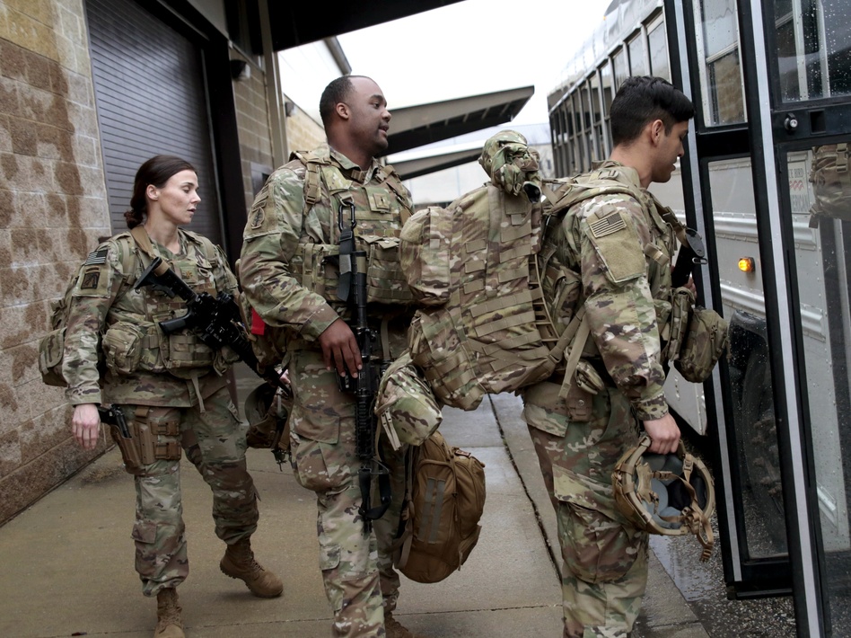 U.S. Army soldiers board a bus in January 2020 at Fort Bragg, N.C., one of the military bases that will likely see population boosts in their 2020 census counts due to a change to how troops deployed abroad were counted. (Chris Seward/AP)