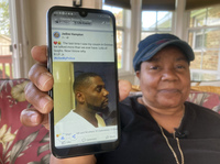 Glenda Brown Thomas displays a photo of her nephew, Andrew Brown Jr., on Thursday. He was shot and killed Wednesday by a sheriff's deputy who was attempting to execute a warrant.