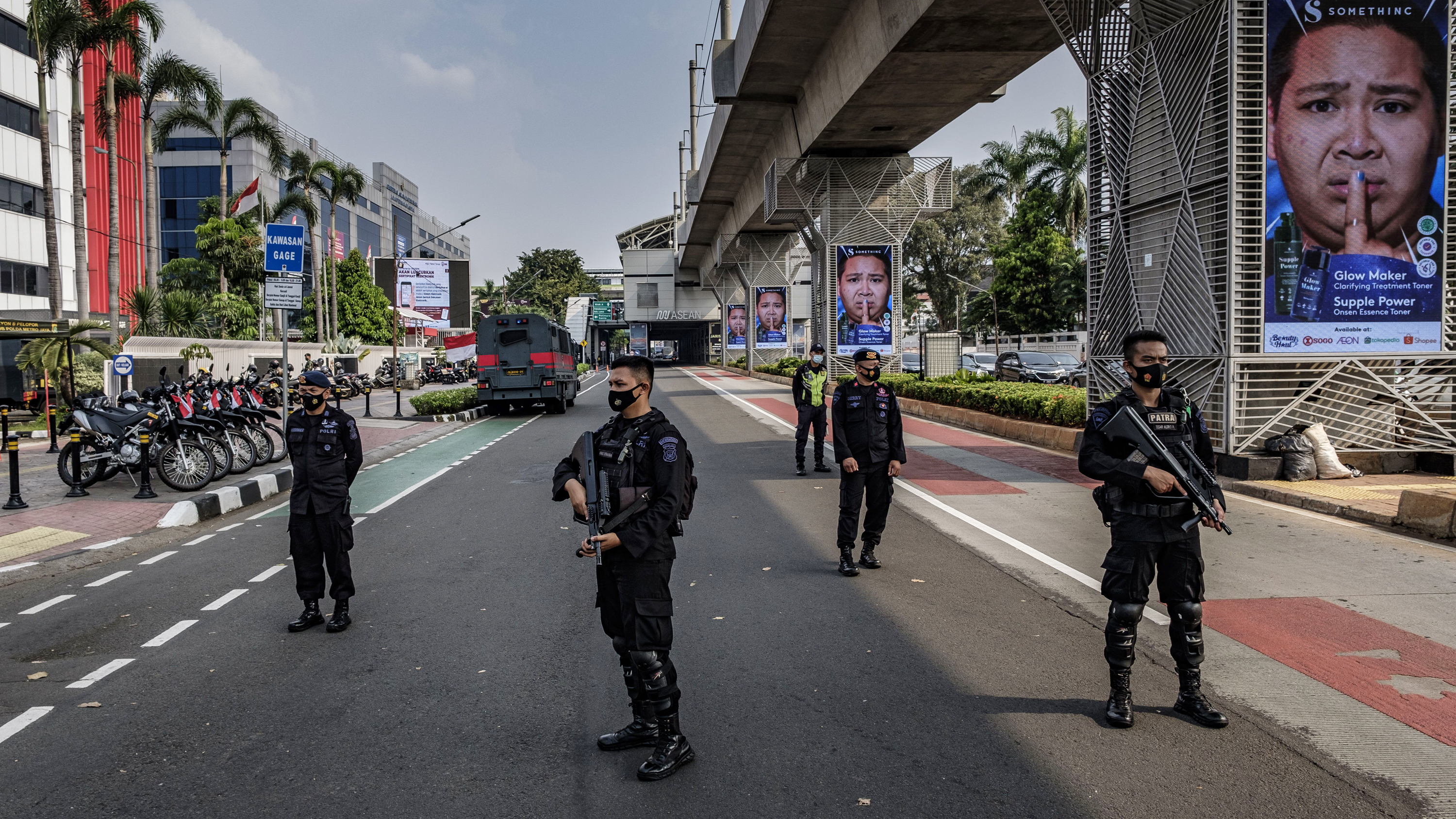 Indonesian police guard the site of Saturday